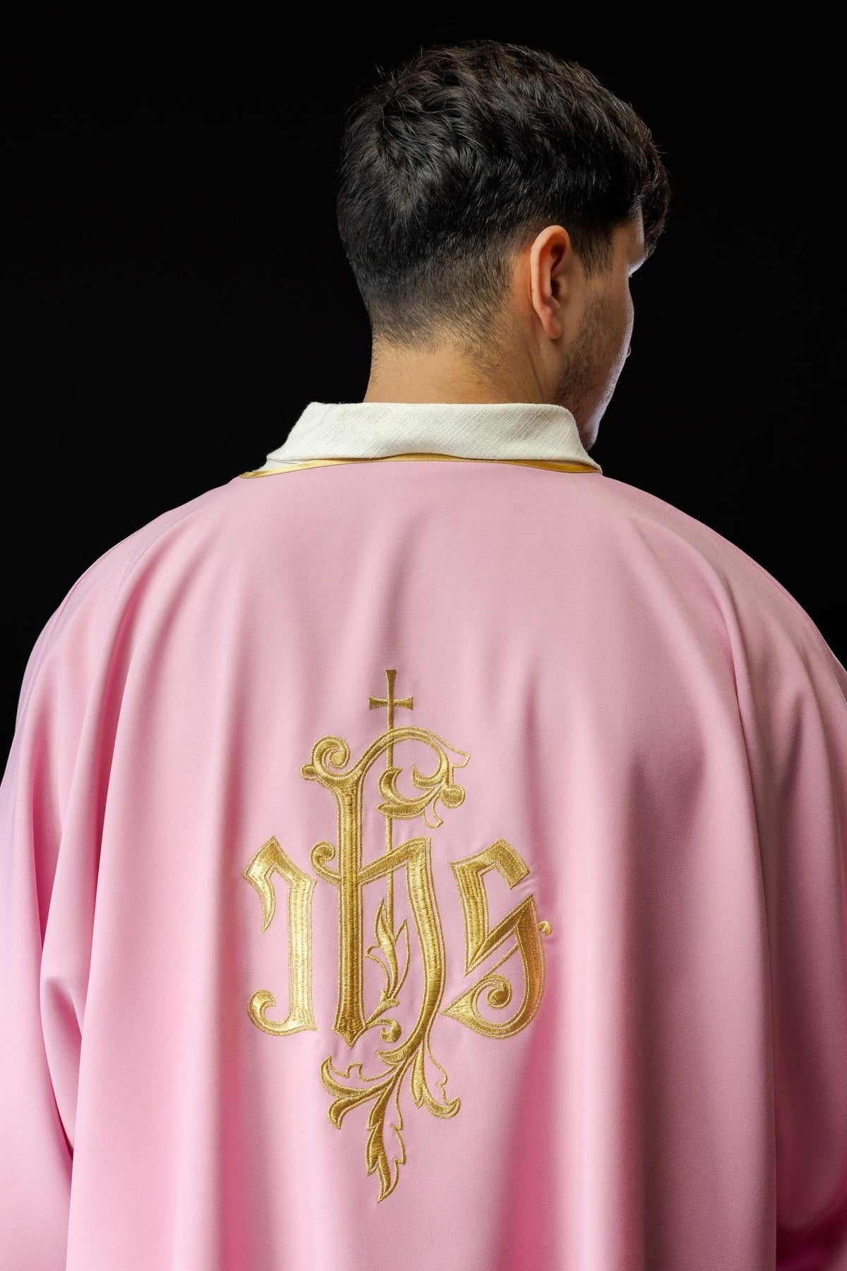 Rose dalmatic back view with gold IHS embroidery and gold trim