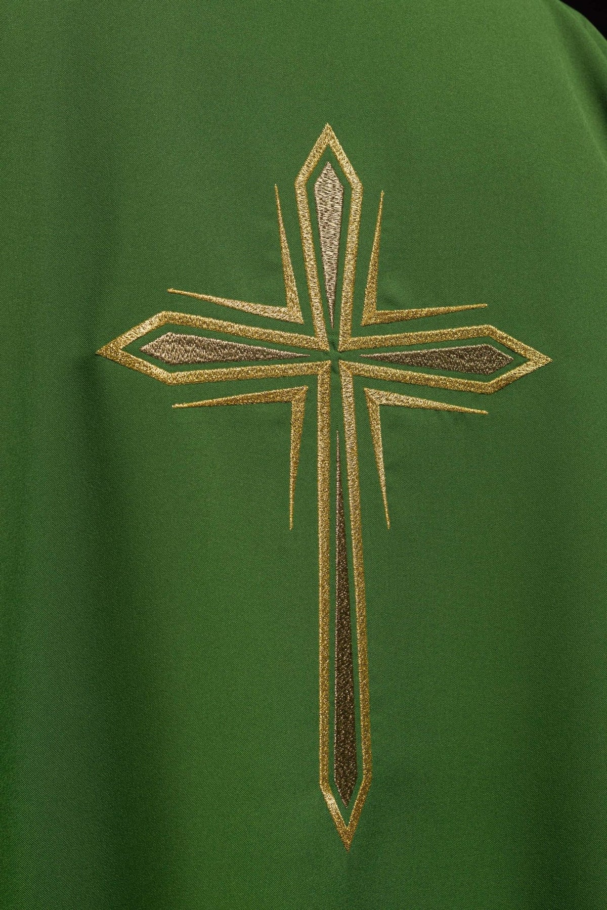 Green dalmatic close-up showing embroidered gold cross