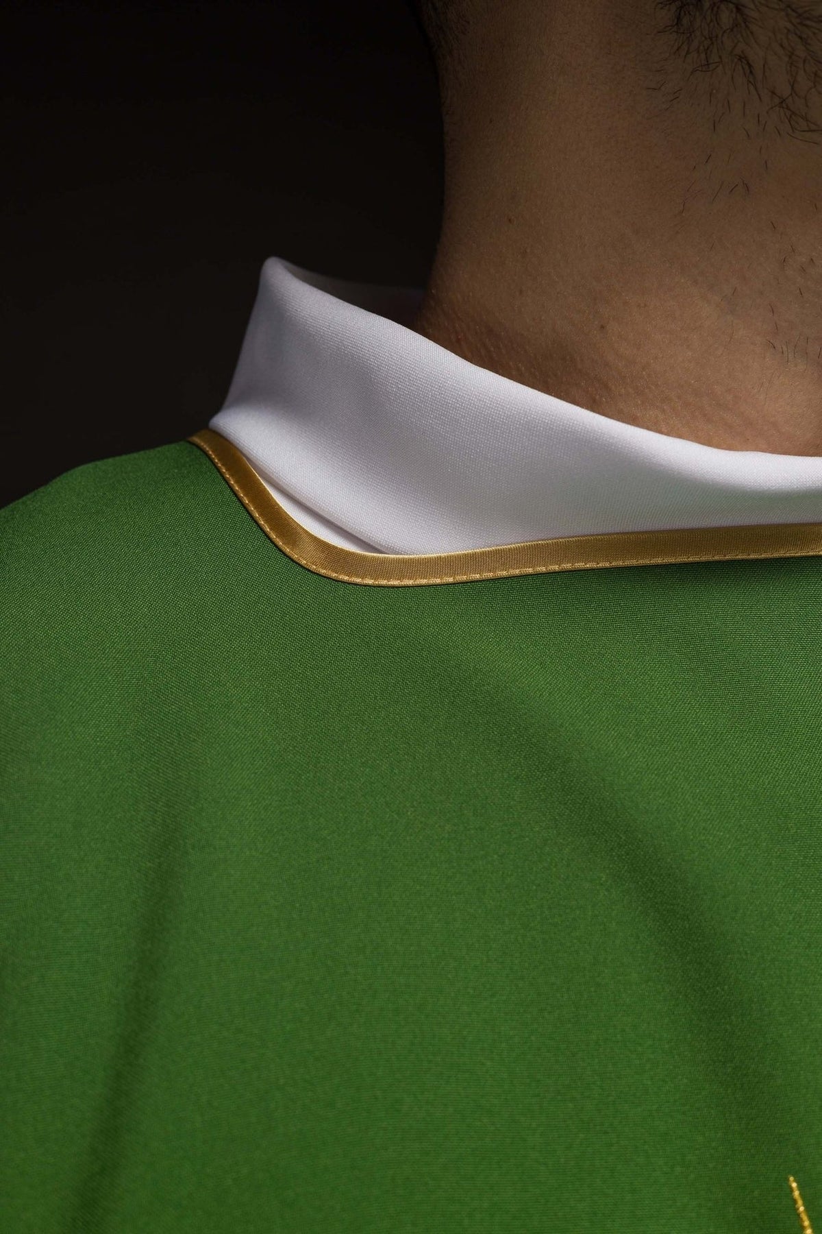 Green dalmatic close-up showing white collar and gold trim