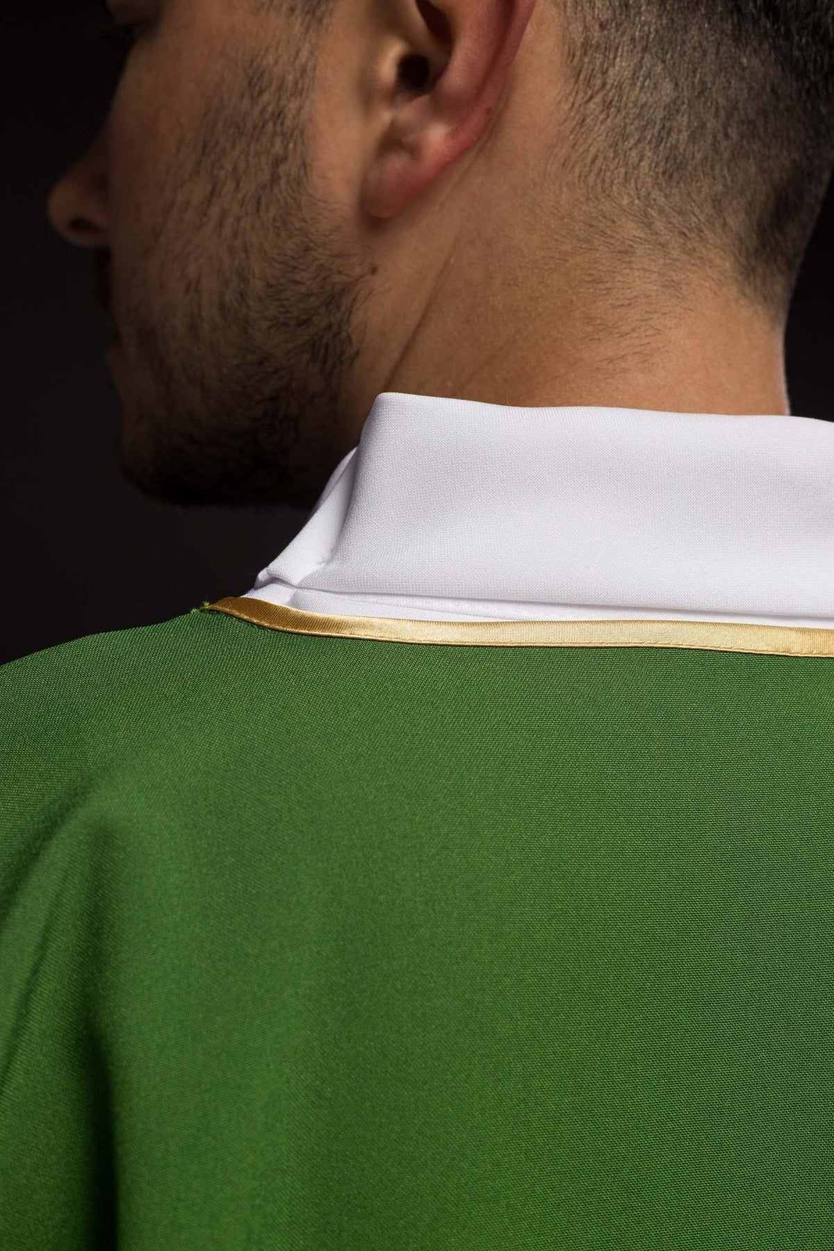 Green dalmatic back close-up with white collar and gold trim