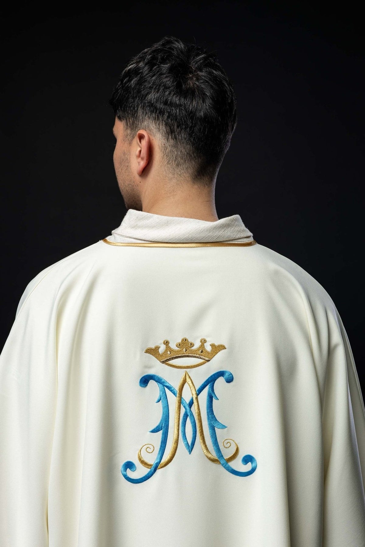Ecru dalmatic back close-up with gold-trimmed collar and Marian embroidery