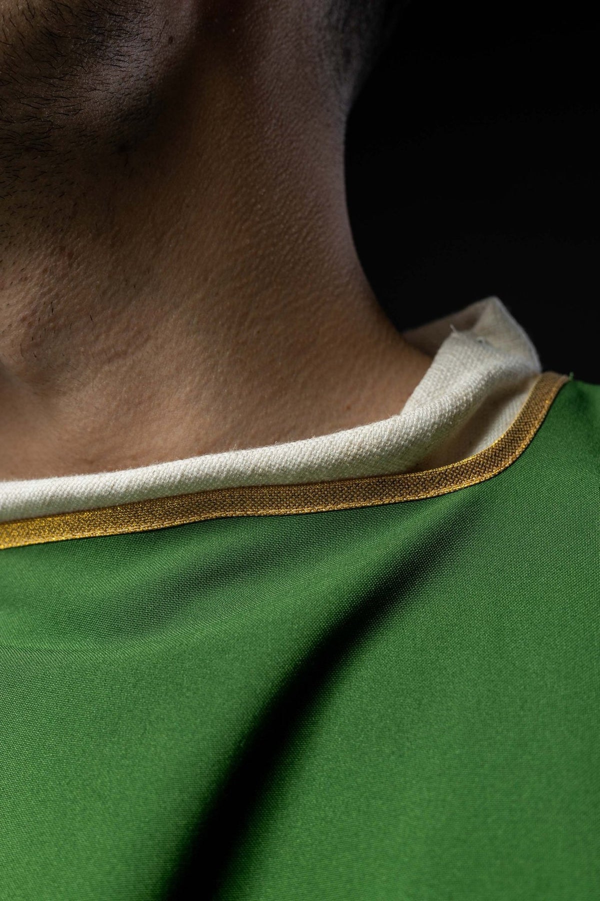 Green dalmatic gold trim close-up at the collar