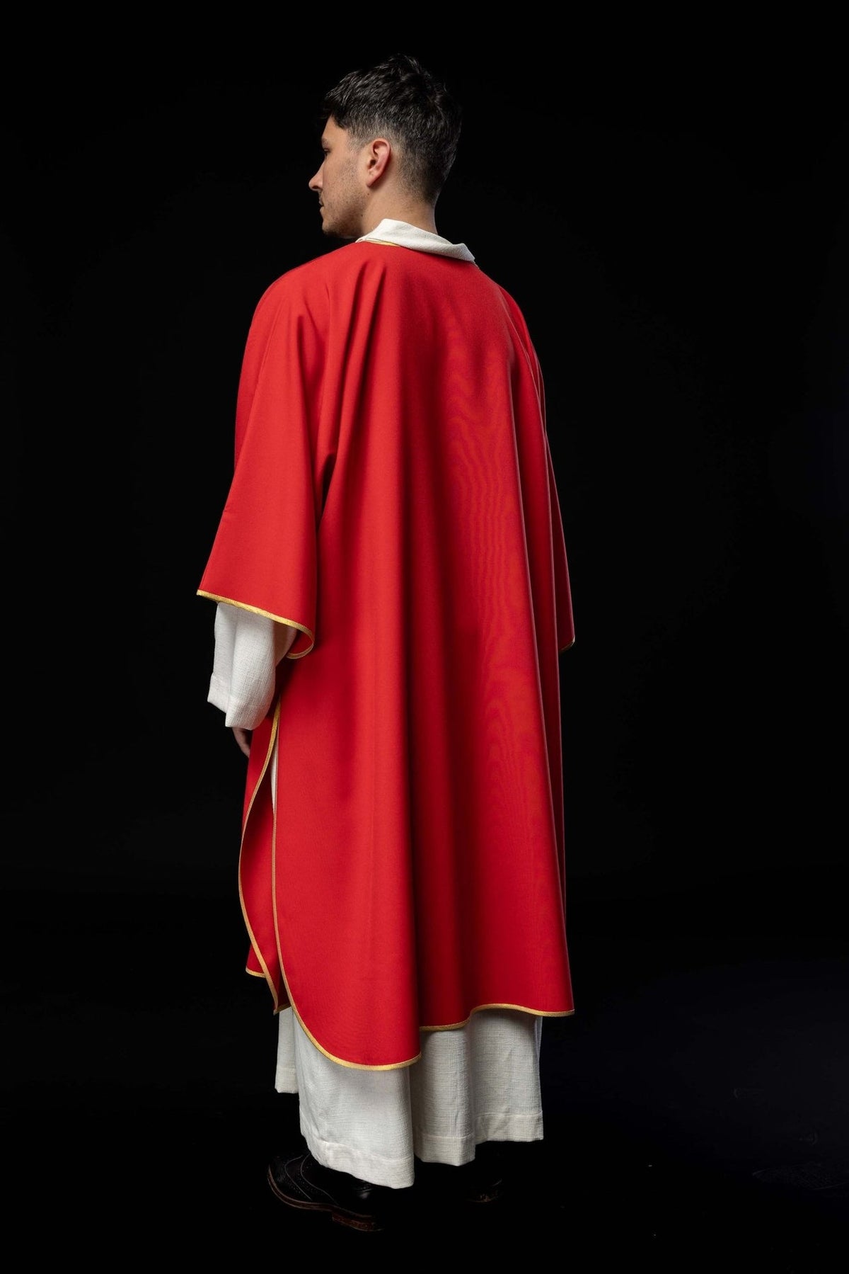 Red dalmatic back view with gold-trimmed edges