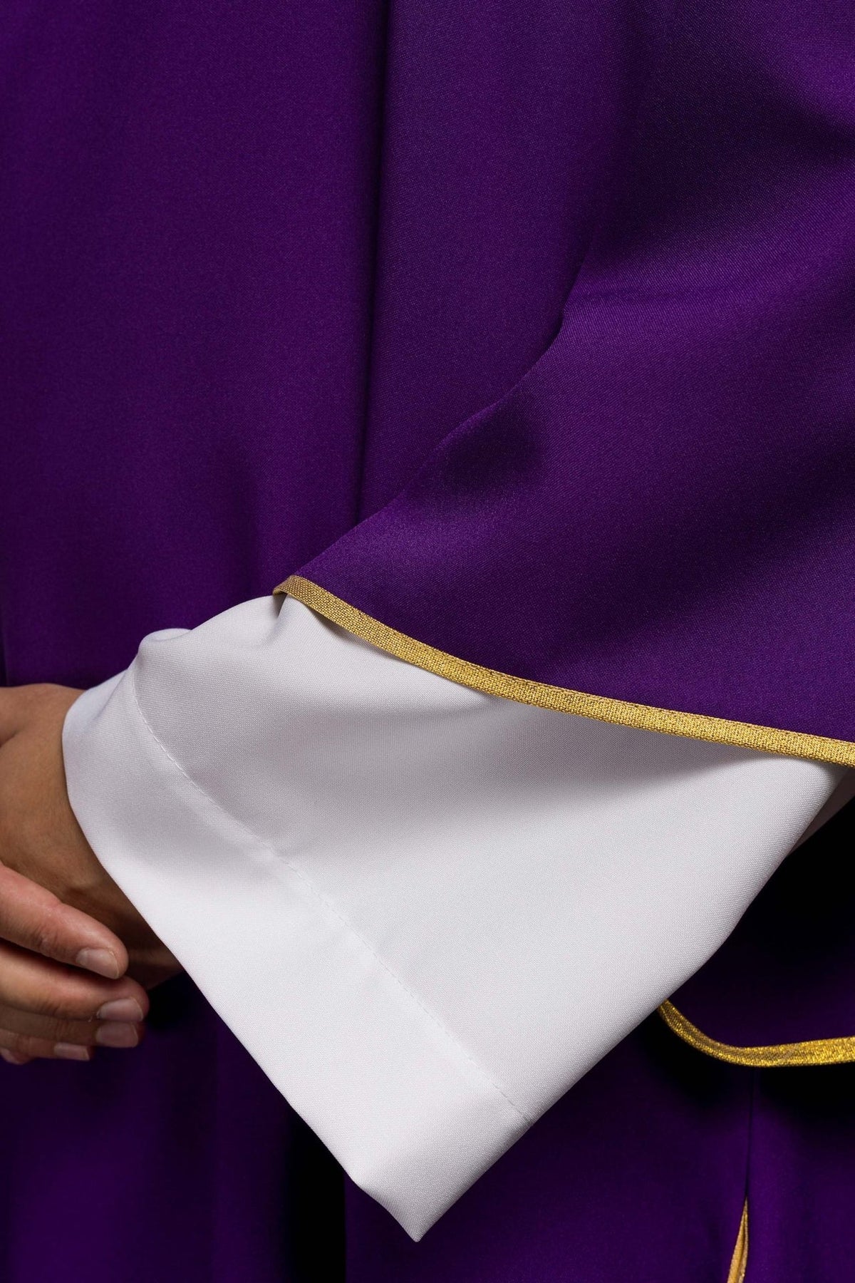 Purple dalmatic close-up showing gold sleeve trim and white cuff