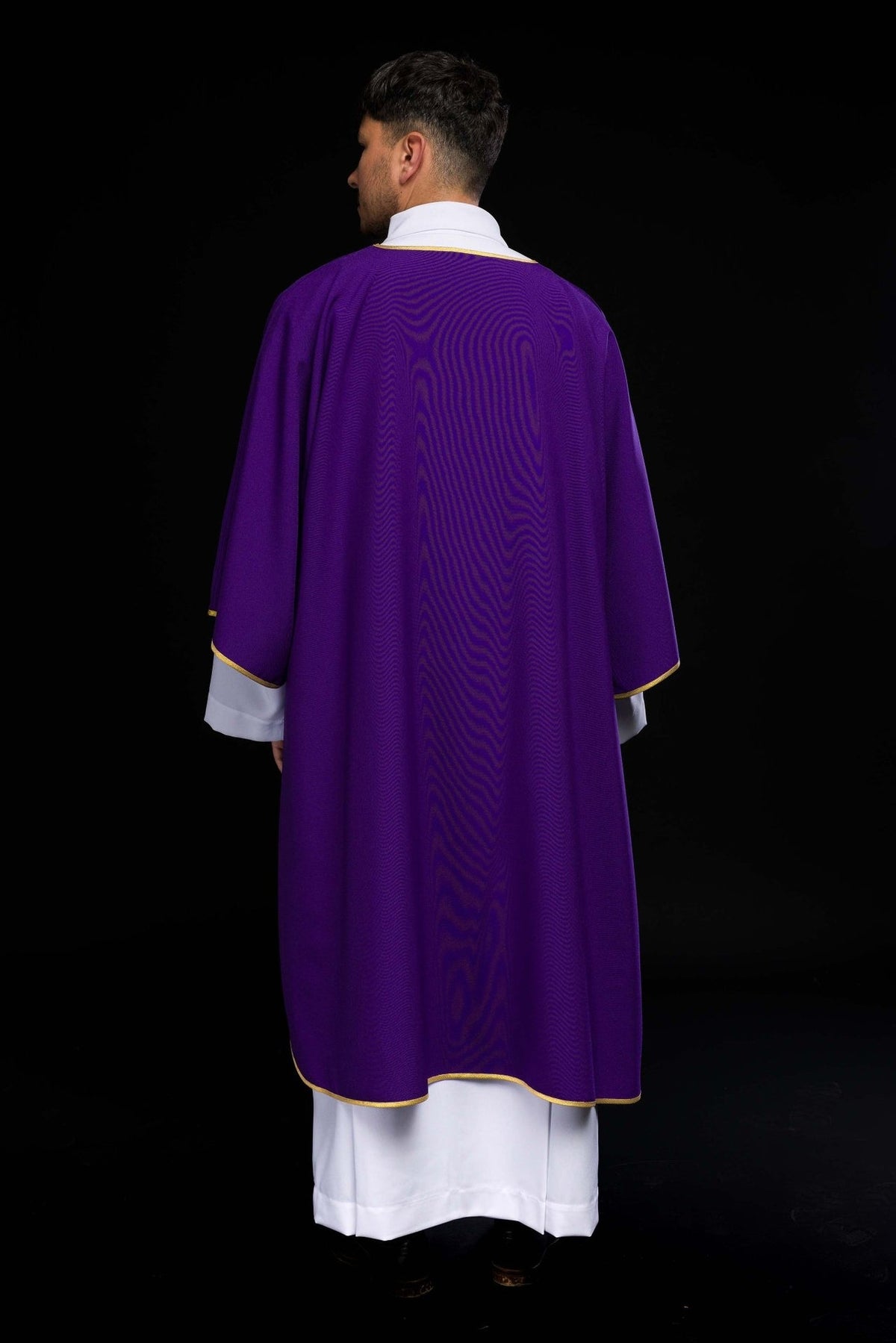 Purple dalmatic worn from the side, showing gold edging