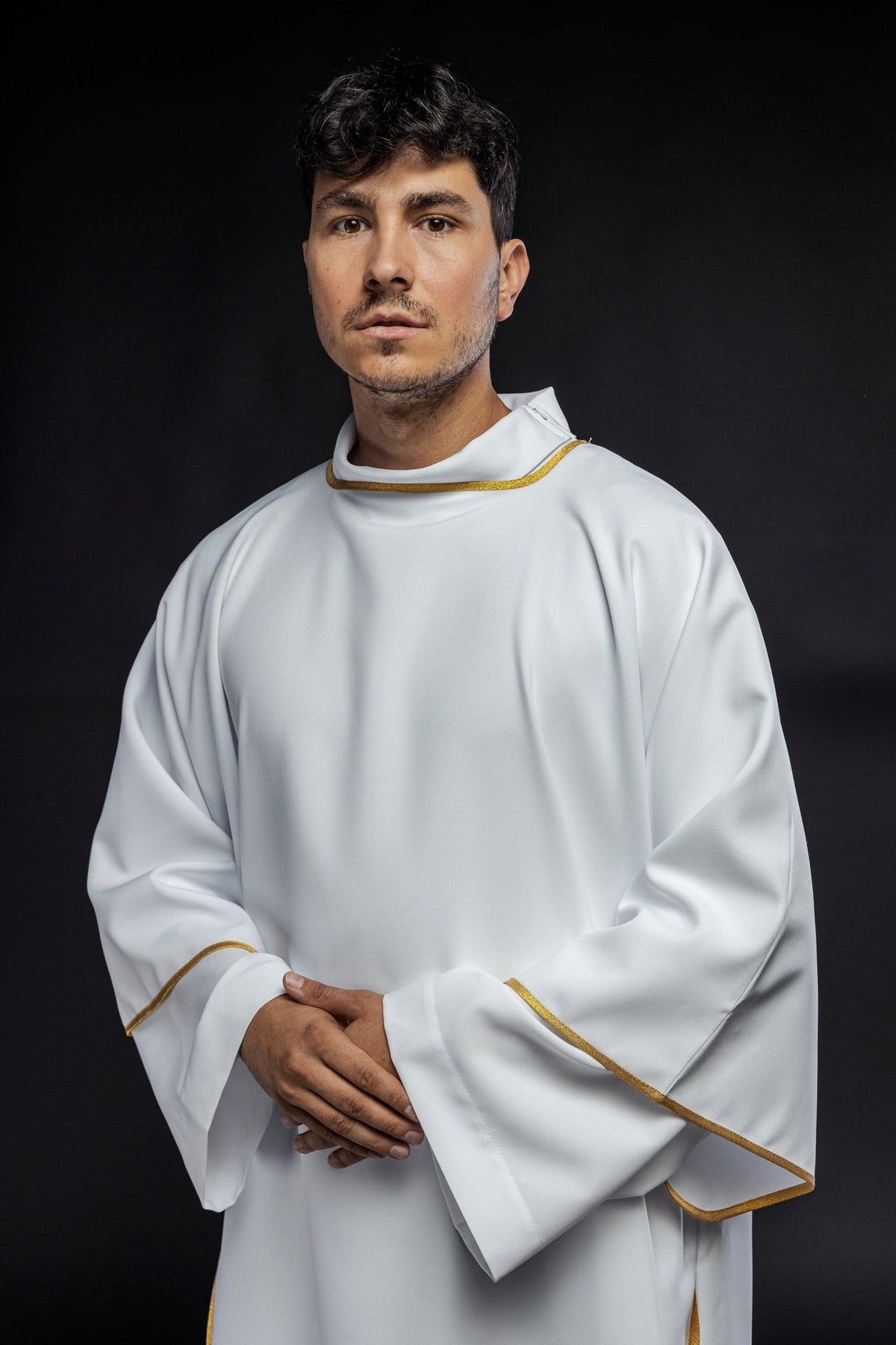White dalmatic with gold trim, close front view of the collar and sleeve edging
