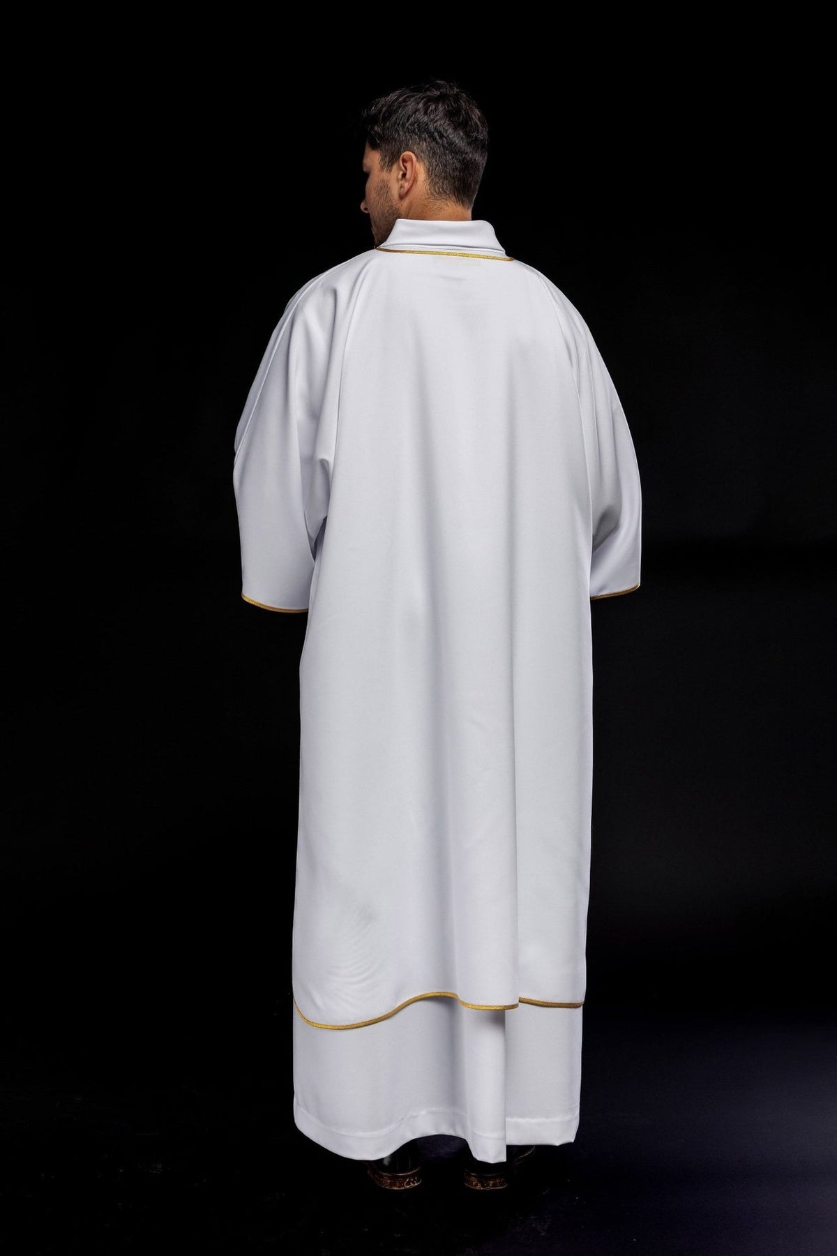 White dalmatic with gold trim, full back view with gold-edged sleeves and hem