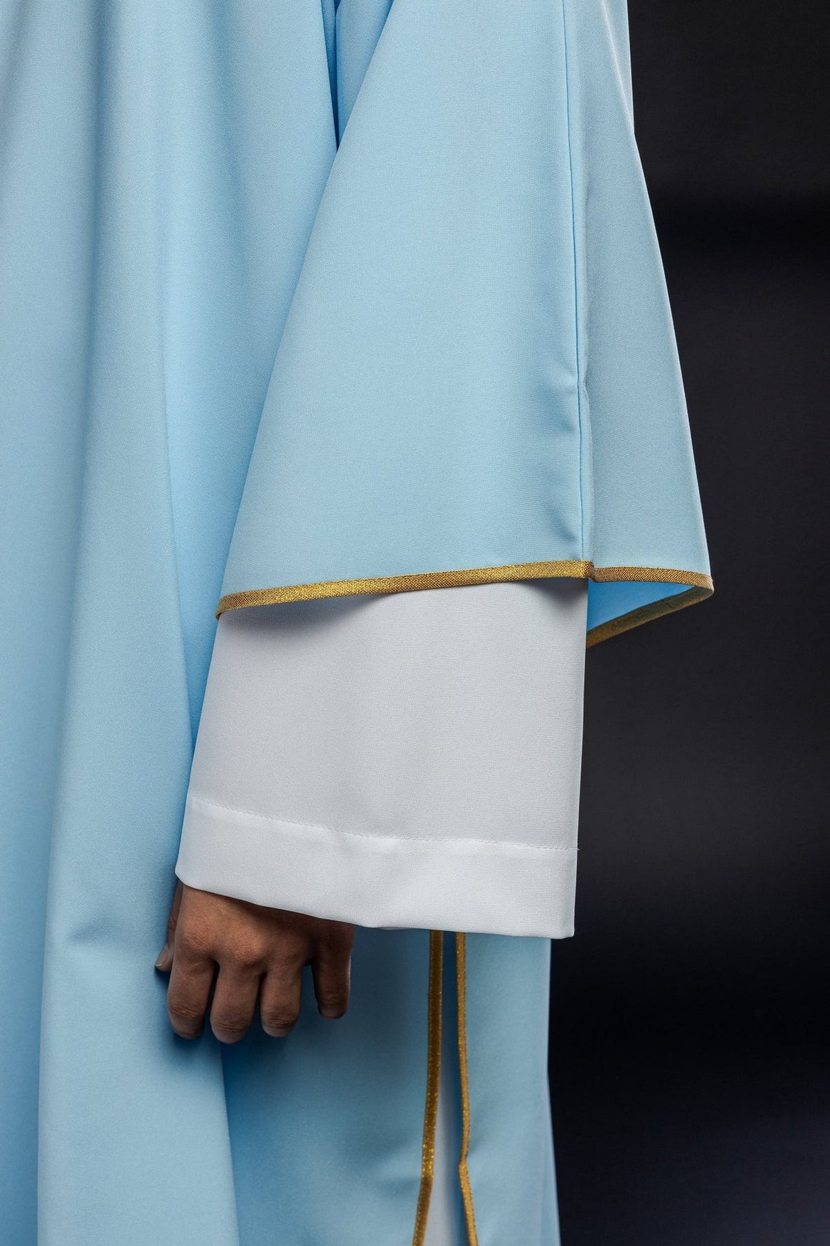 Blue dalmatic, close-up of sleeve with gold trim and white cuff