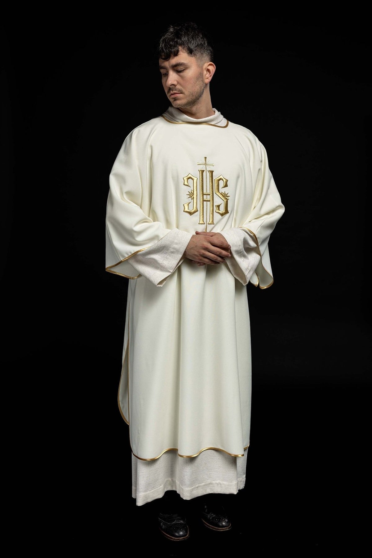 Dalmatic worn front view with gold IHS embroidery and wide sleeves