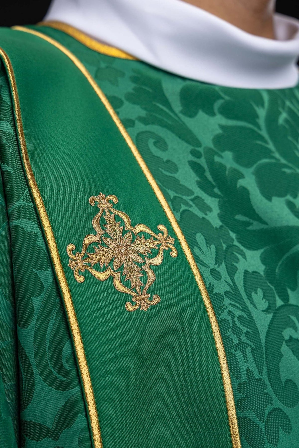 Green dalmatic close-up of gold embroidered cross on the orphrey