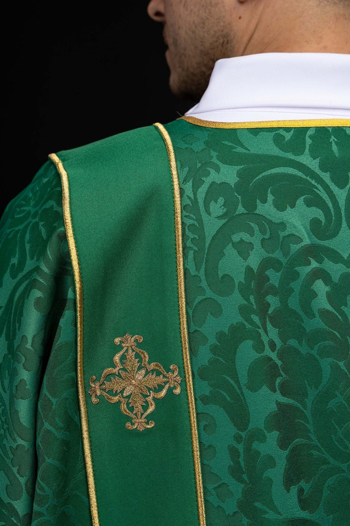 Green dalmatic back detail with gold orphrey trim and embroidered cross