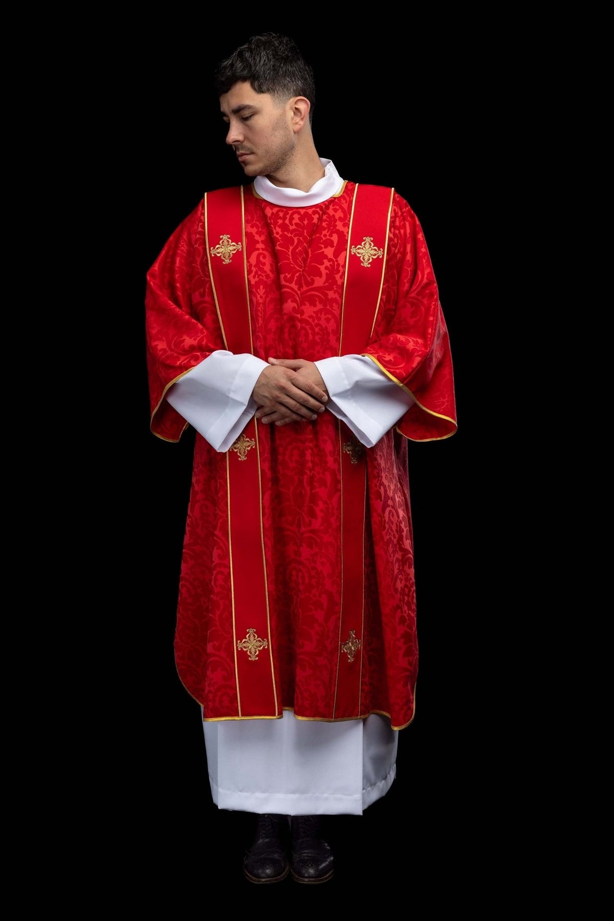 Red dalmatic front view showing gold orphrey trim and embroidered crosses