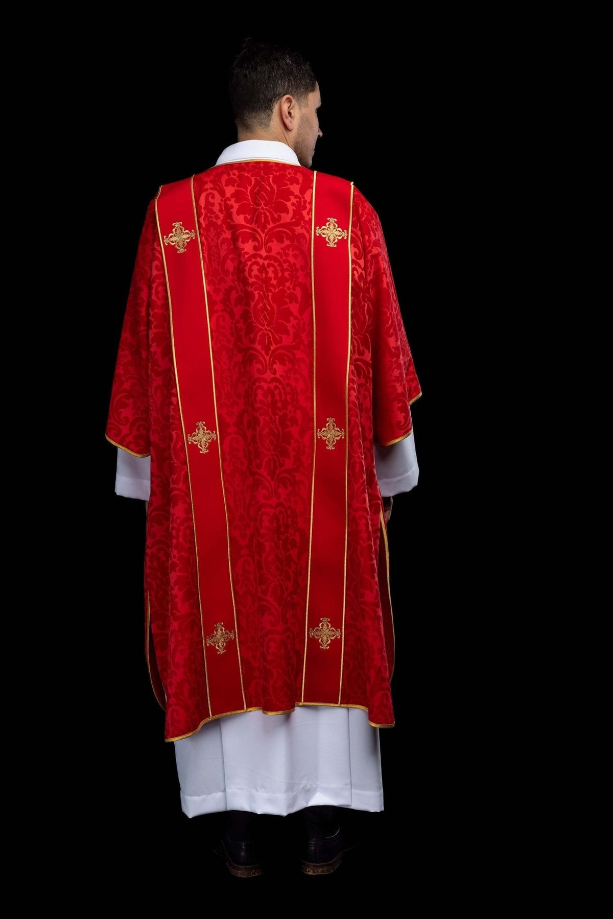 Red dalmatic rear view showing patterned jacquard fabric and gold orphrey trim