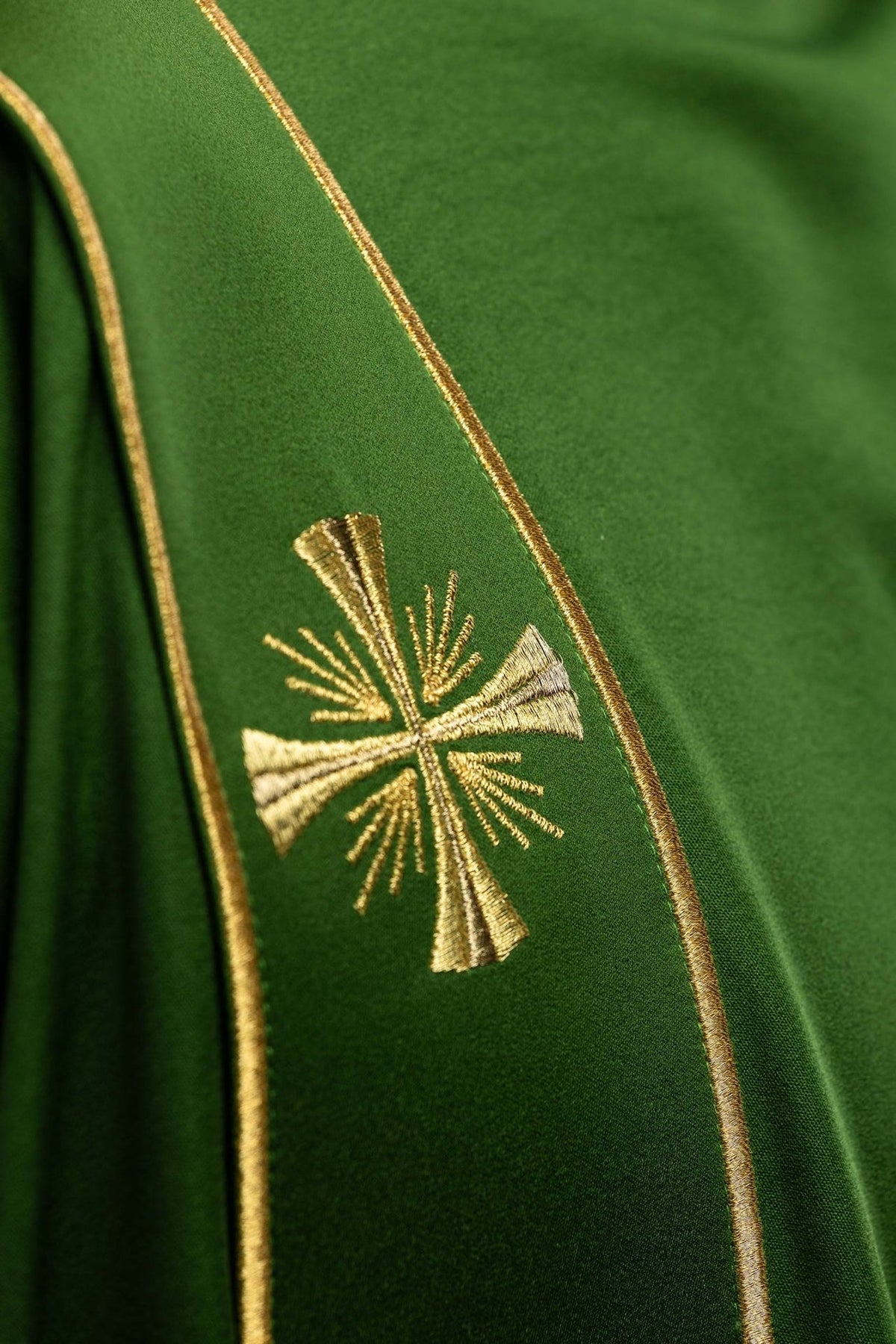 Green dalmatic embroidered gold cross and orphrey close-up