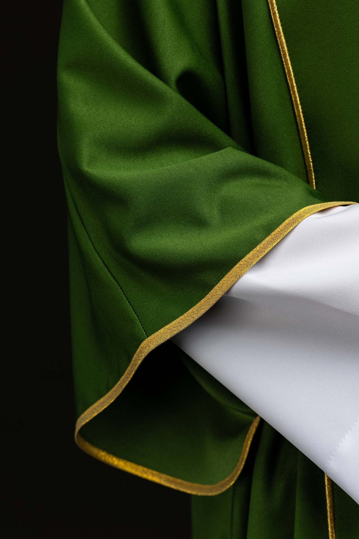 Green dalmatic sleeve with gold trim close-up