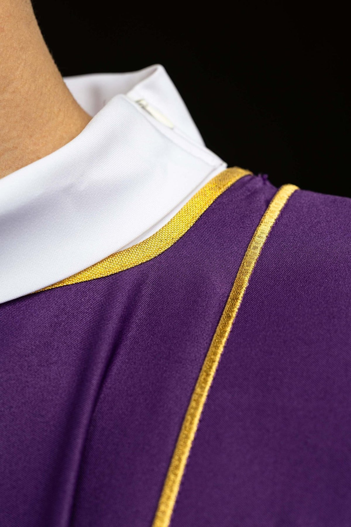 Purple dalmatic close-up showing white collar and gold trim