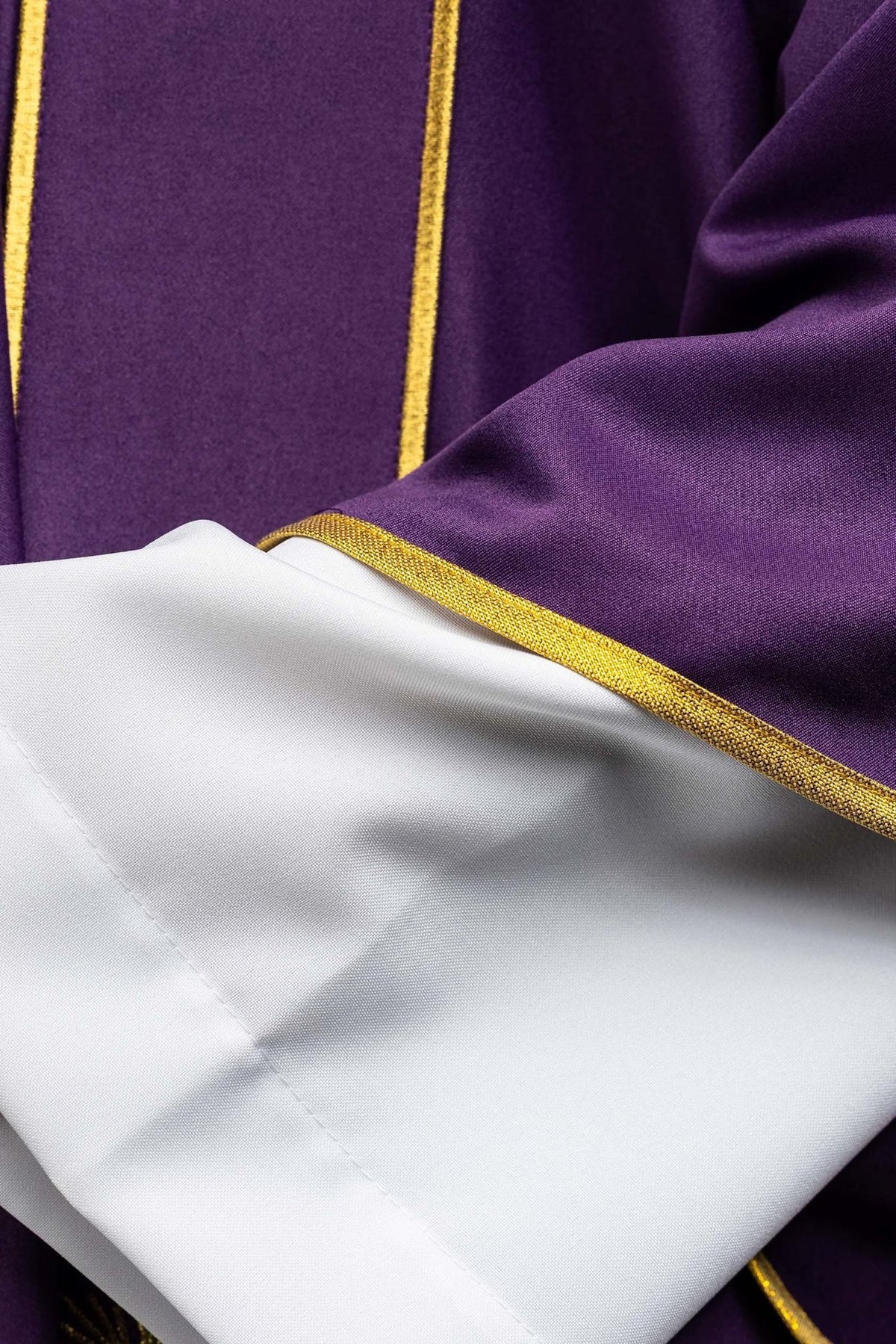 Purple dalmatic close-up showing sleeve trim and white fabric