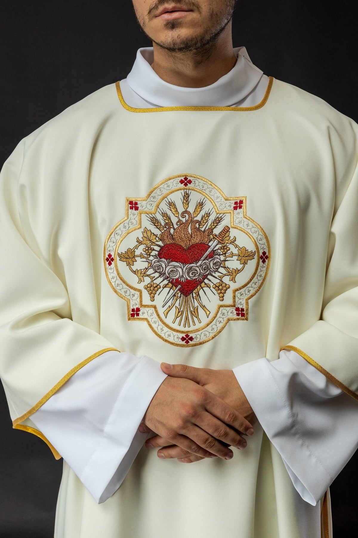 Ecru dalmatic front close-up with Heart of Mary embroidery and gold trim