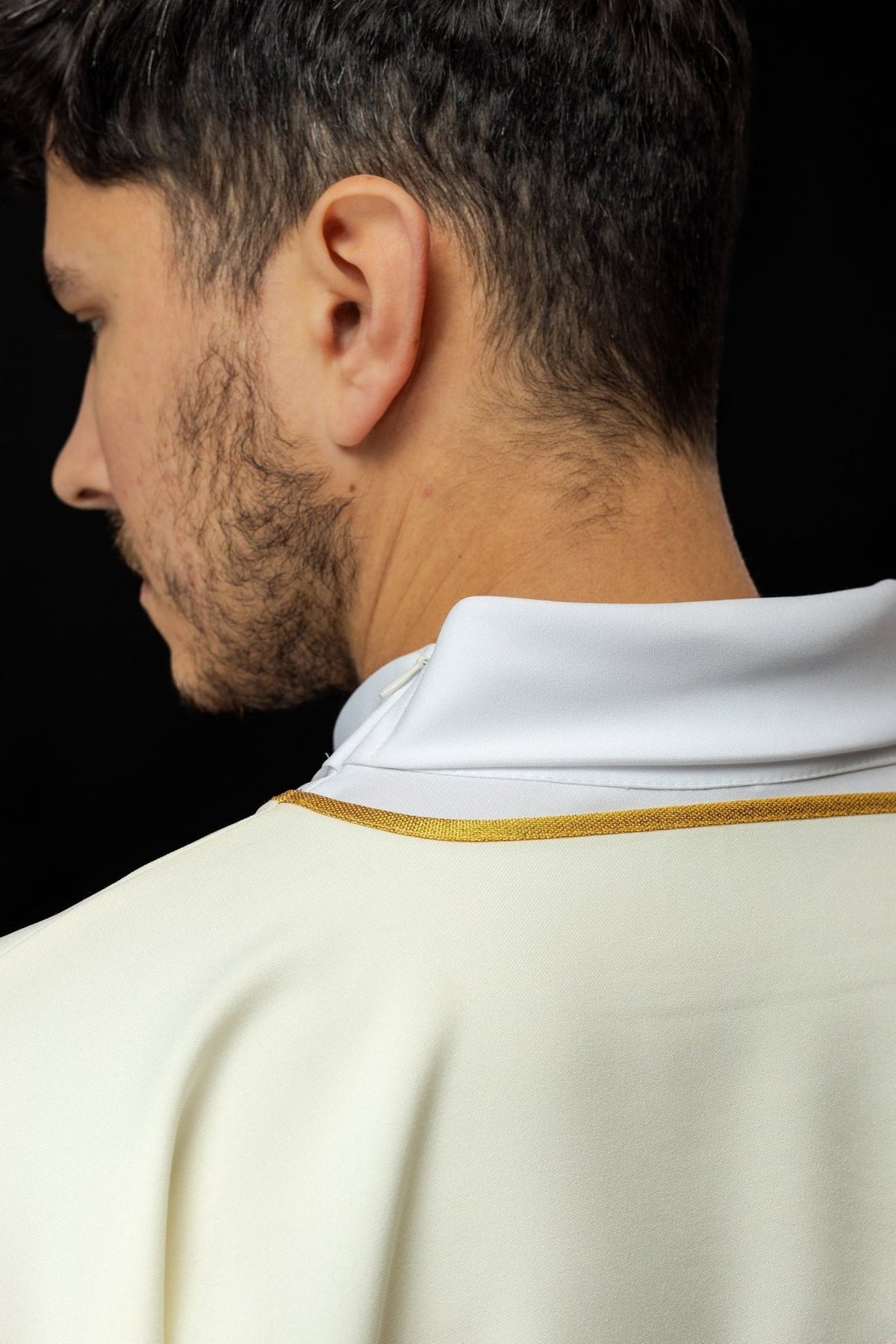 Ecru dalmatic side close-up with gold trim and Heart of Mary embroidery