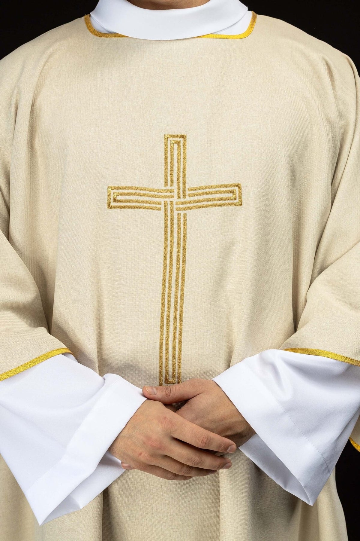Ecru dalmatic front close-up showing embroidered gold cross