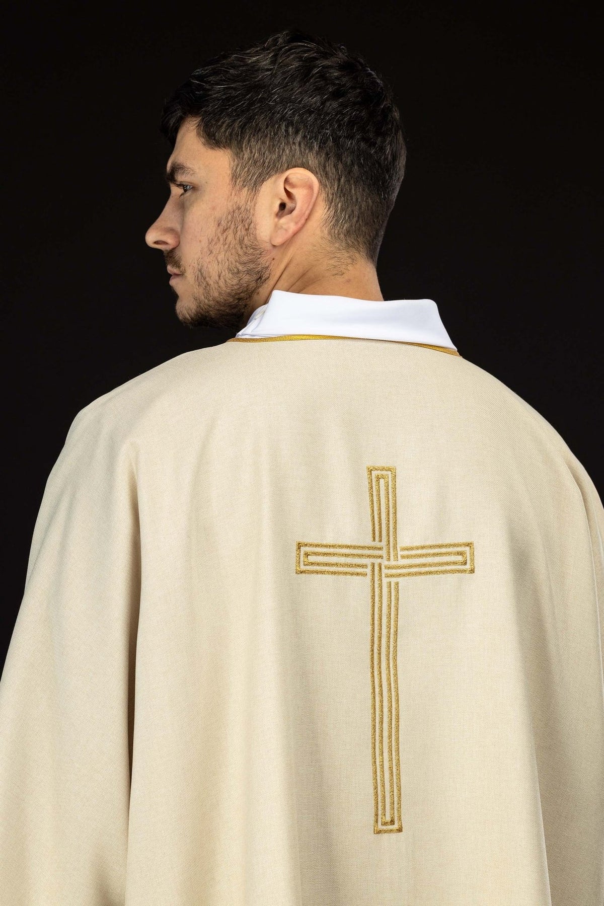 Ecru dalmatic back close-up with embroidered gold cross