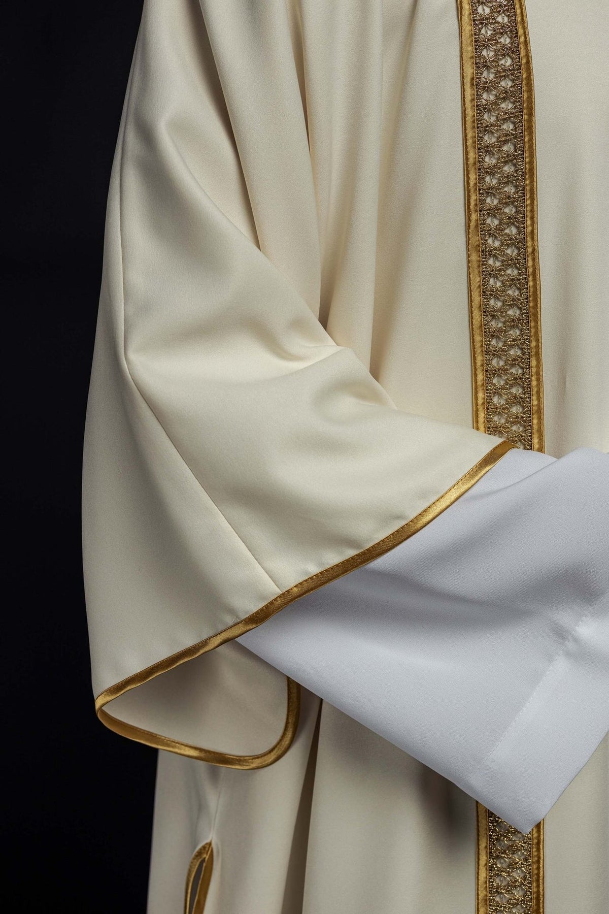 Ecru dalmatic sleeve with gold trim and white cuff