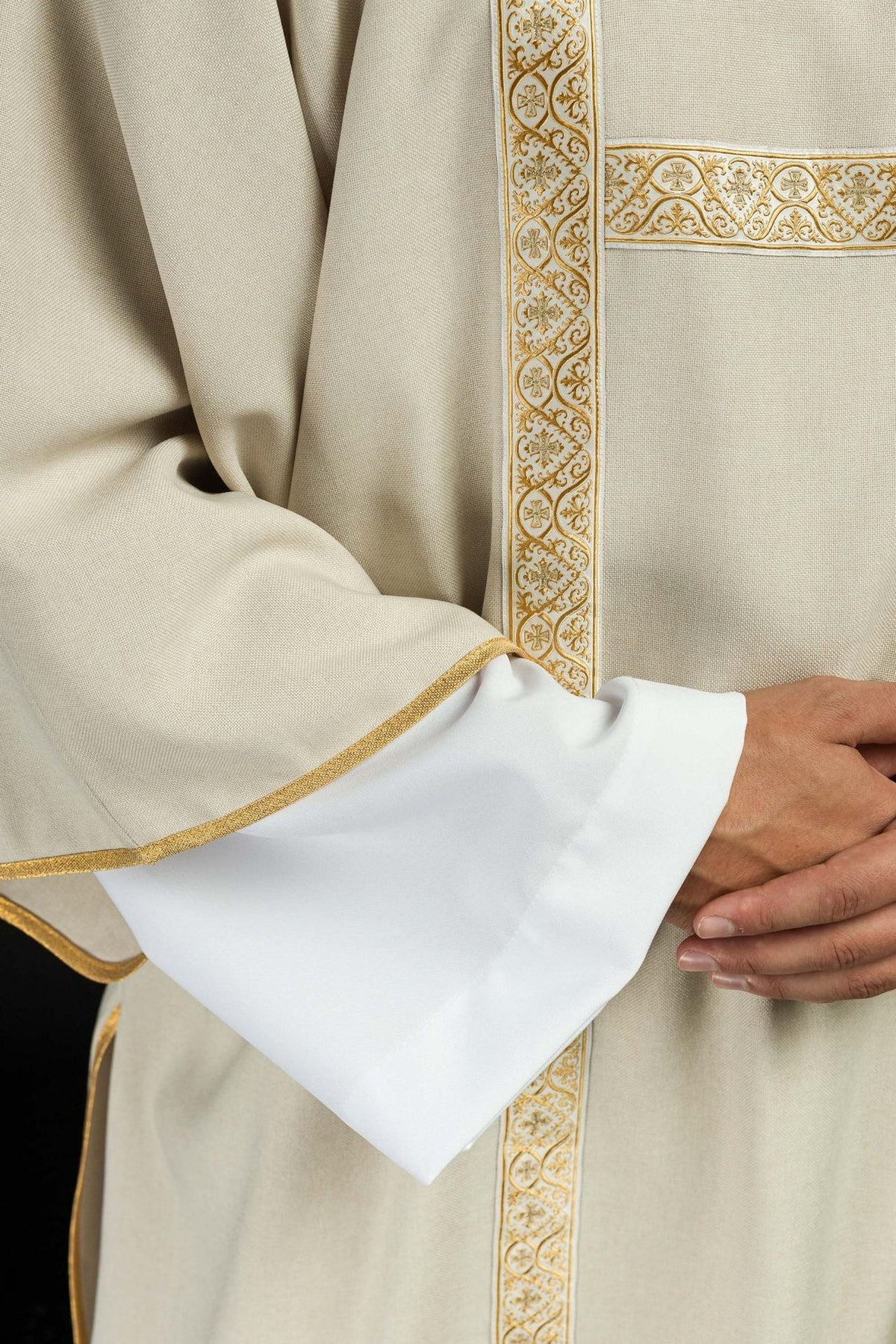 Ecru dalmatic close-up showing gold trim, sleeve edge and white cuffs