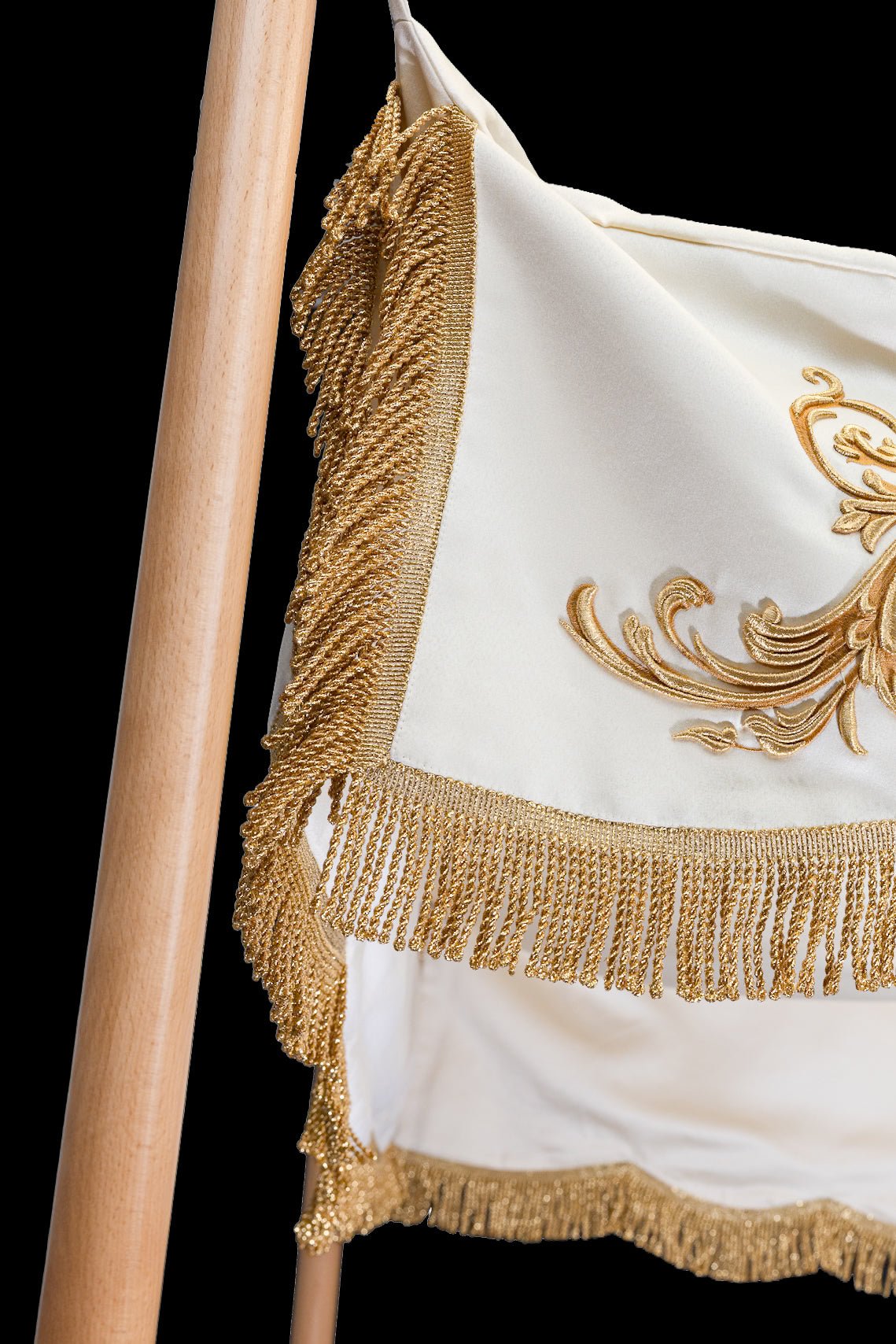 Canopy detail showing gold fringe, ecru fabric and side embroidery