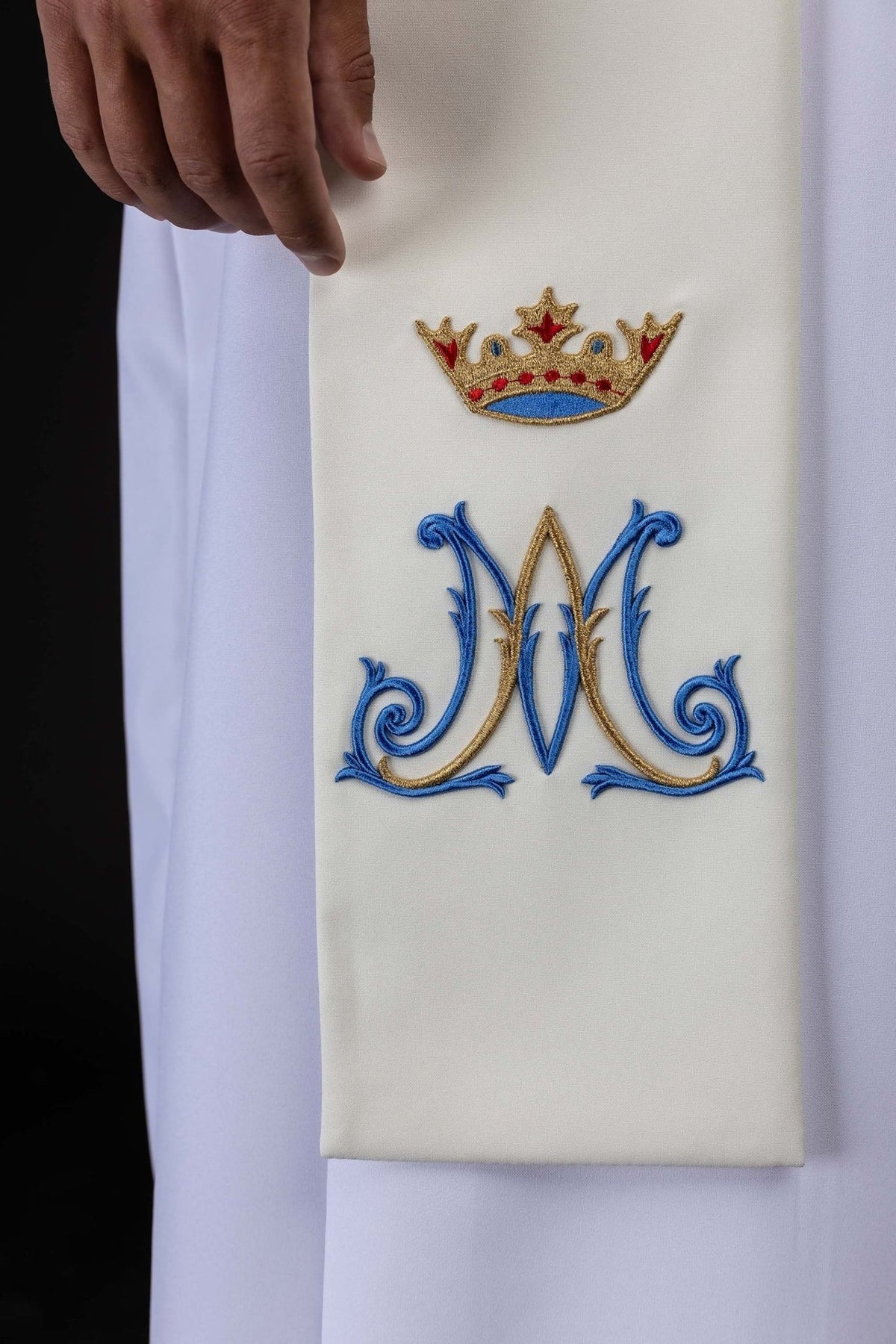 Ecru Marian stole close-up with embroidered blue Marian symbol and crown
