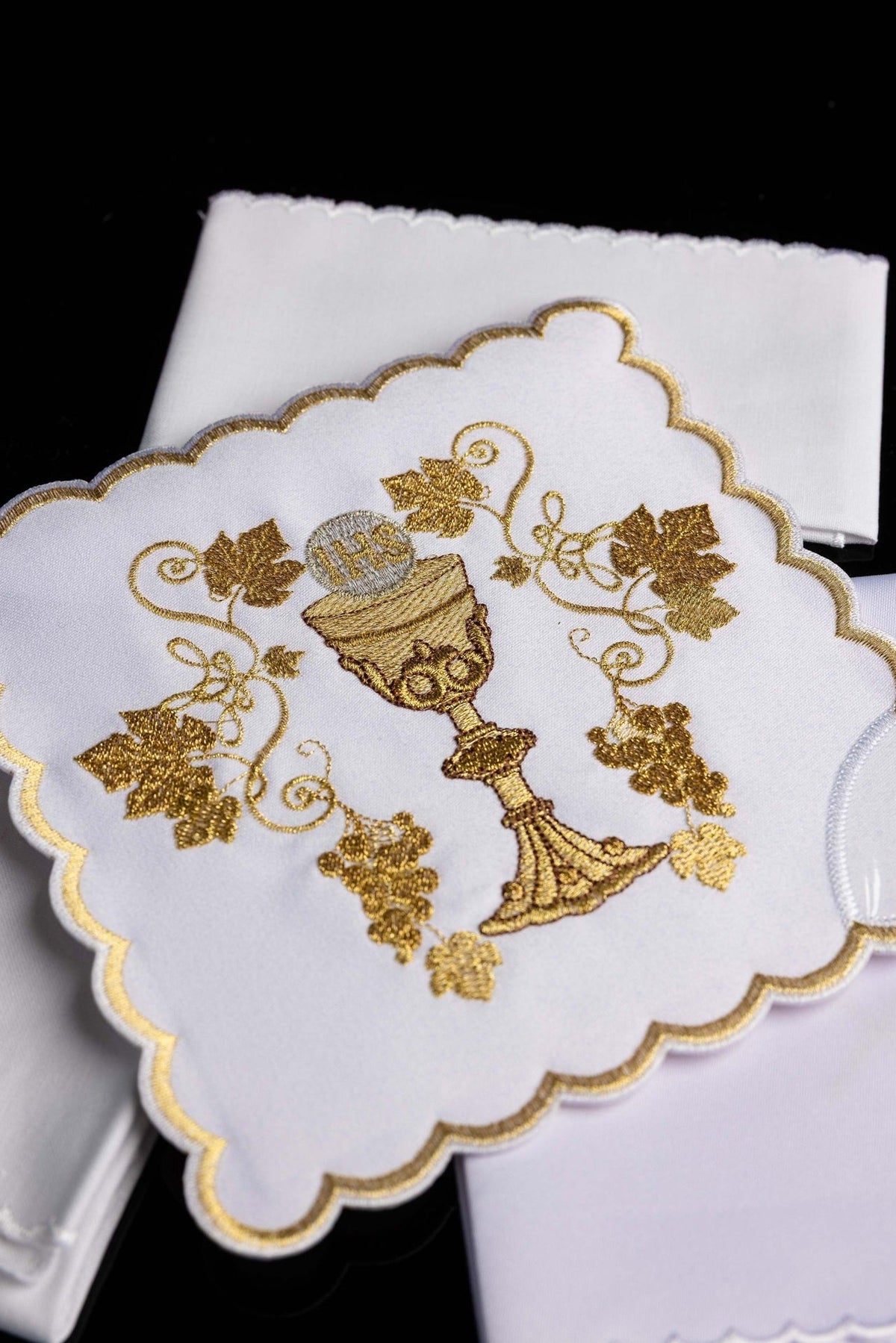 Altar linen set close-up showing gold embroidered chalice, grapevines and scalloped edging