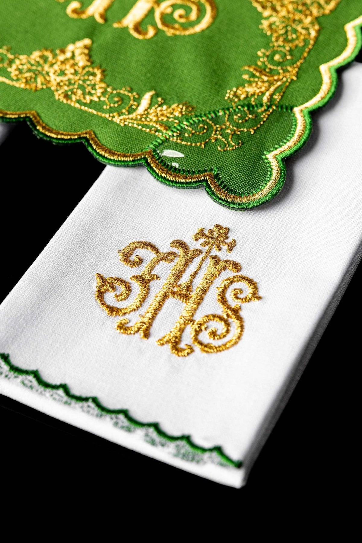 Altar linen set close-up showing gold IHS monogram and green scalloped edging