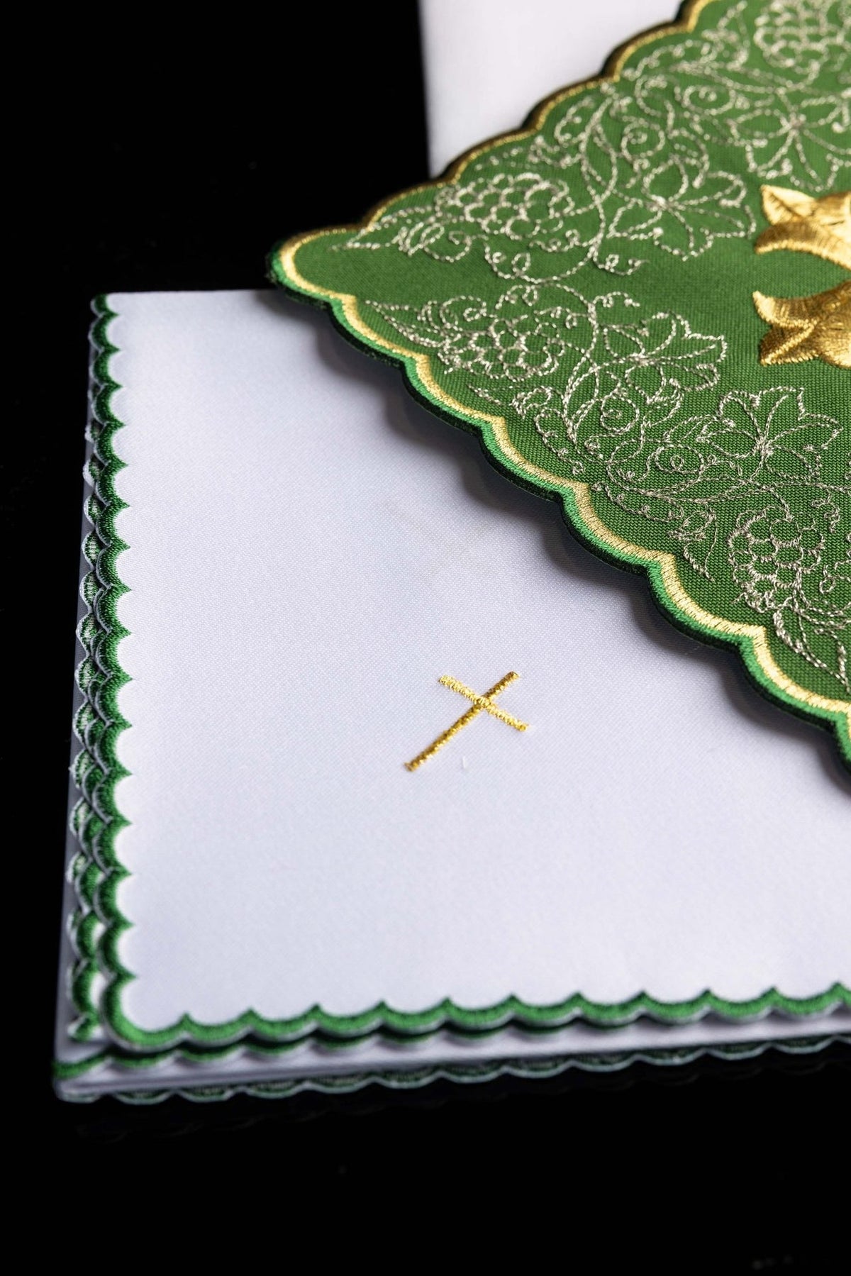 Altar linen set detail showing gold cross embroidery and green scalloped edging