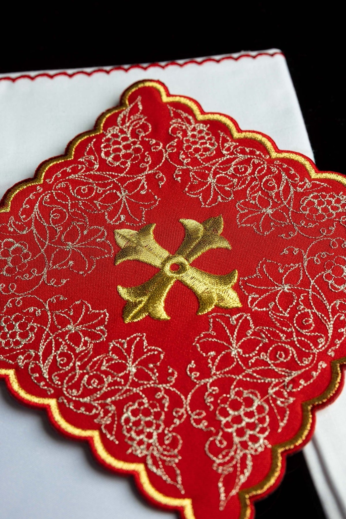 Altar linen set close-up of red floral embroidery and gold cross