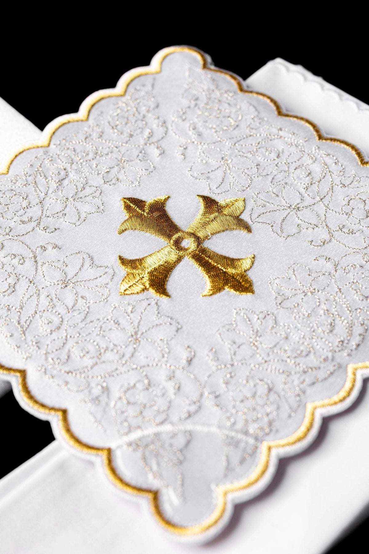 Altar linen set close-up showing gold cross and white floral embroidery