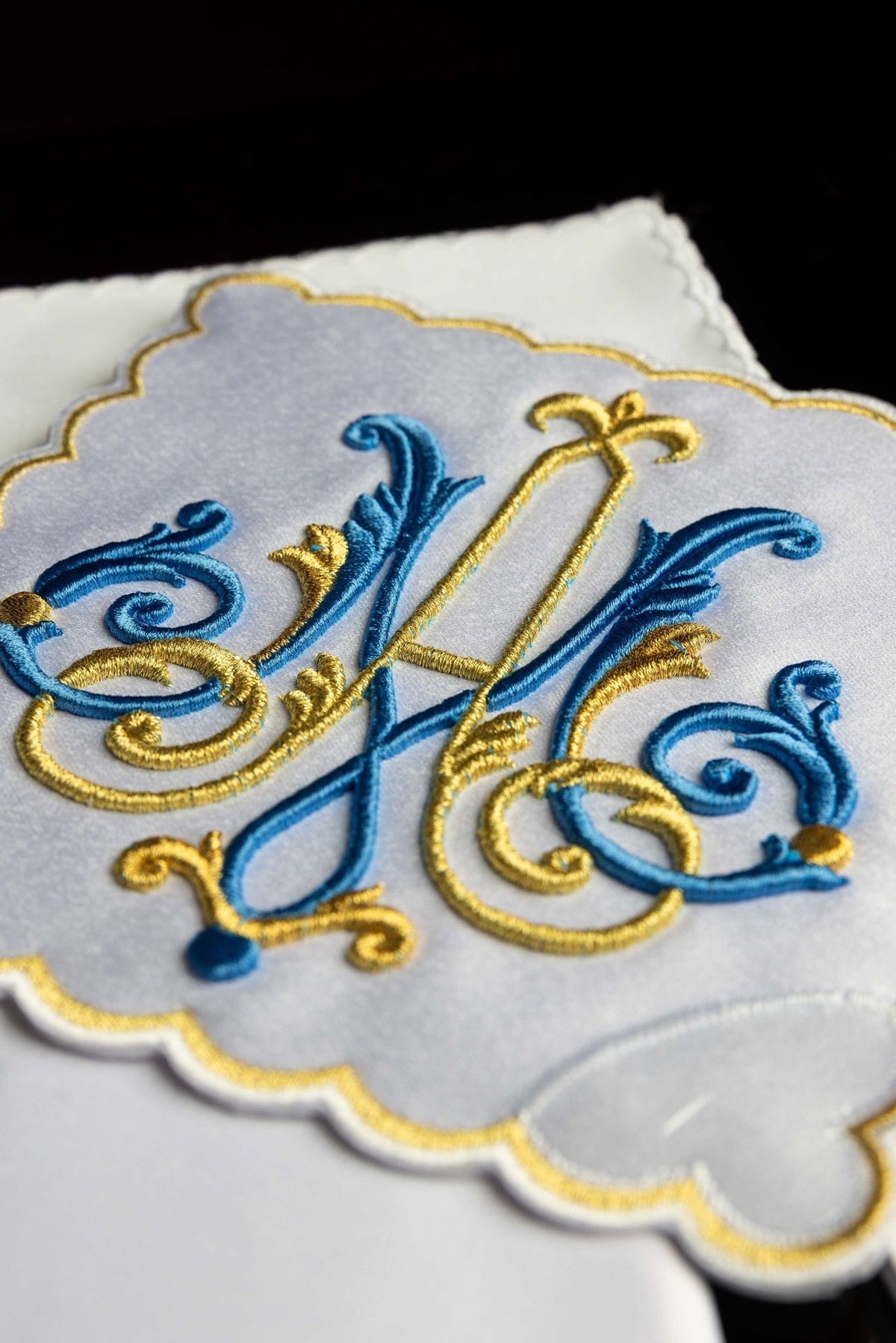 Altar linen set close-up showing blue and gold Marian motif and scalloped edge
