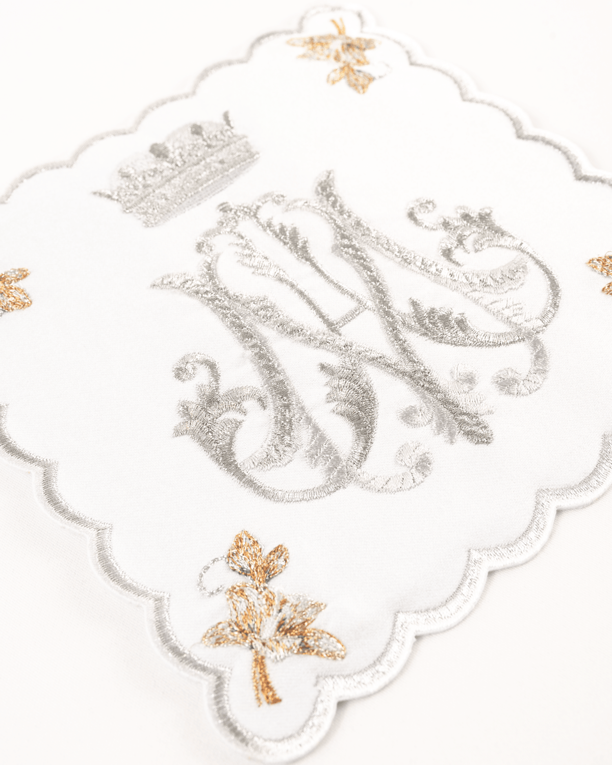 Altar linen set close-up showing silver Marian embroidery, gold floral embroidery and scalloped edging