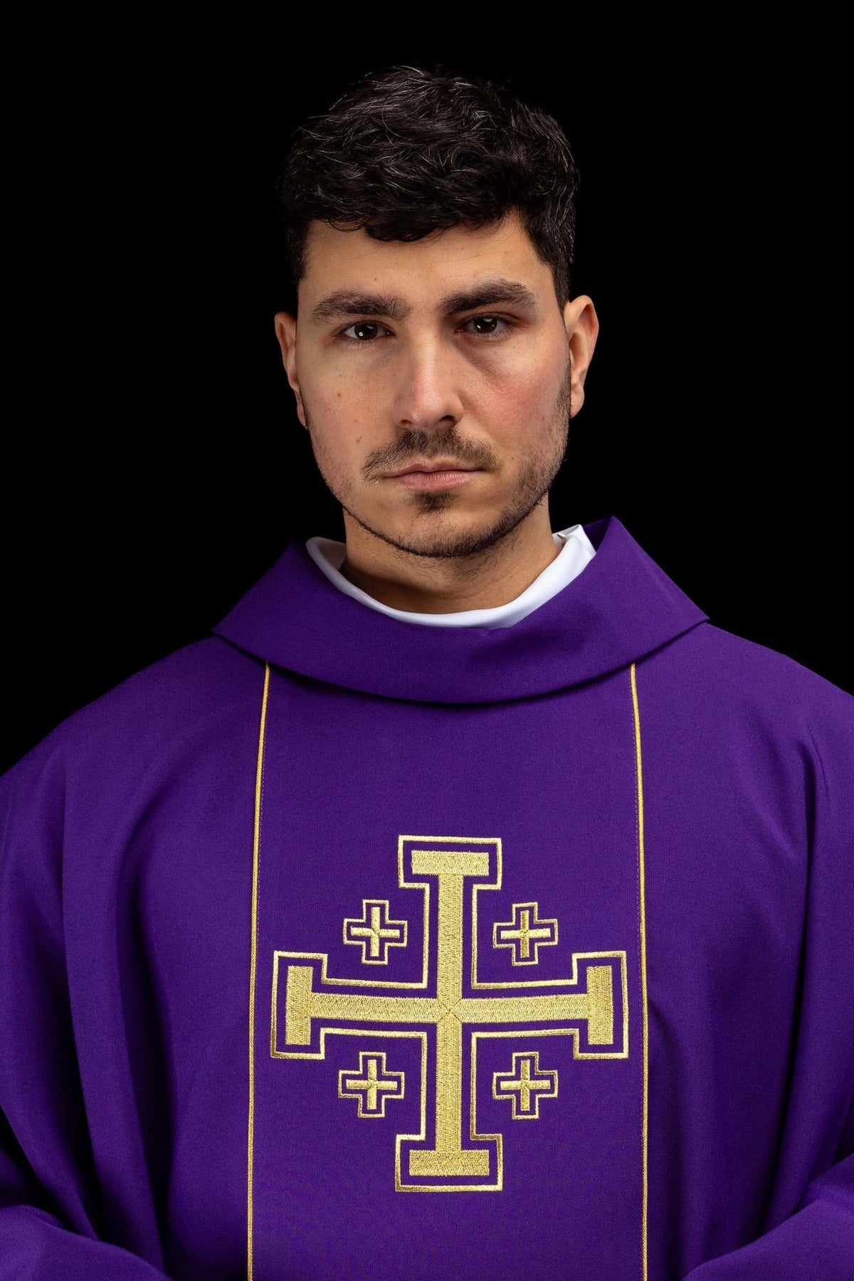 Purple chasuble close-up showing gold Jerusalem cross embroidery and stand-up collar