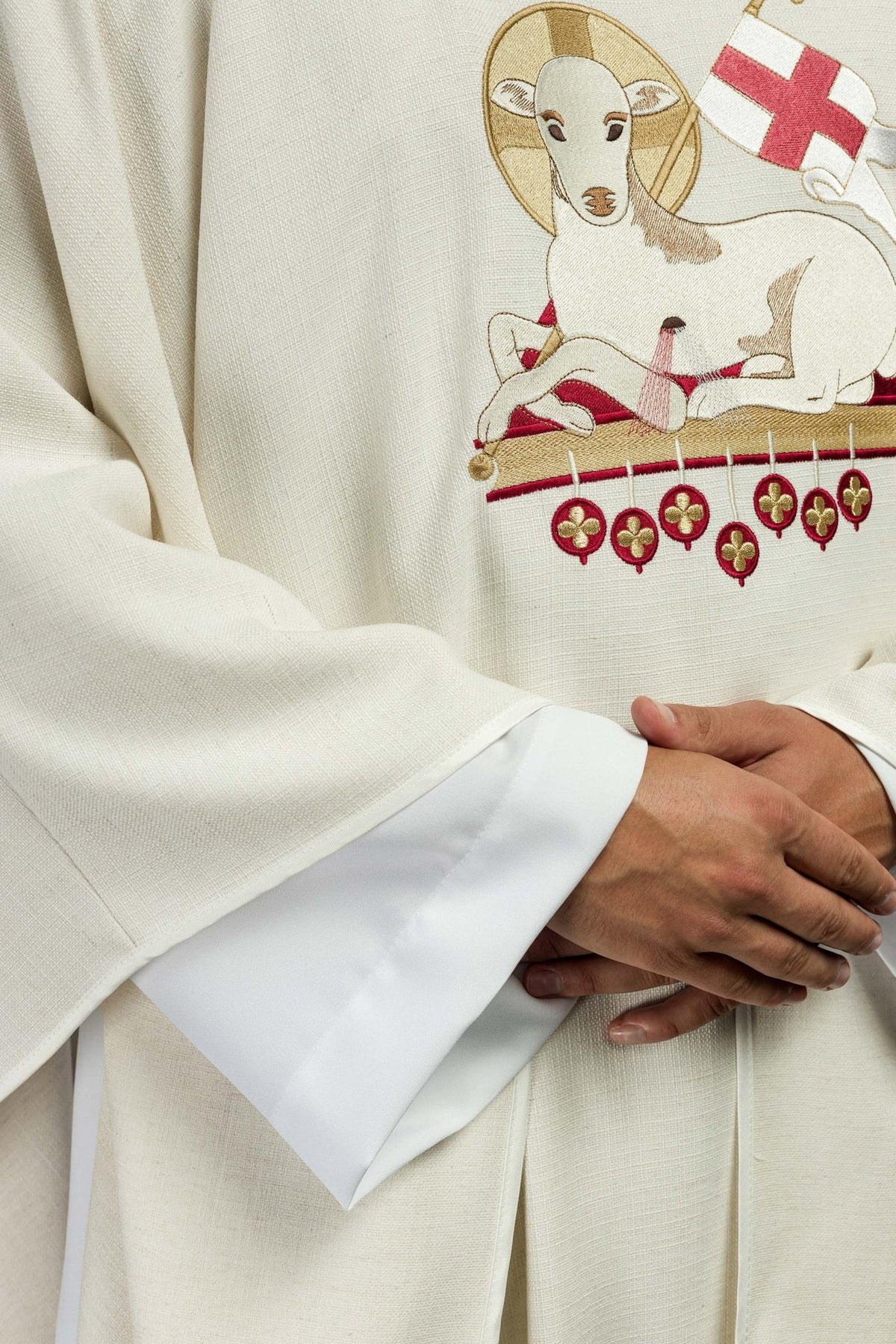 Lamb chasuble close-up showing embroidered Agnus Dei and sleeve fabric