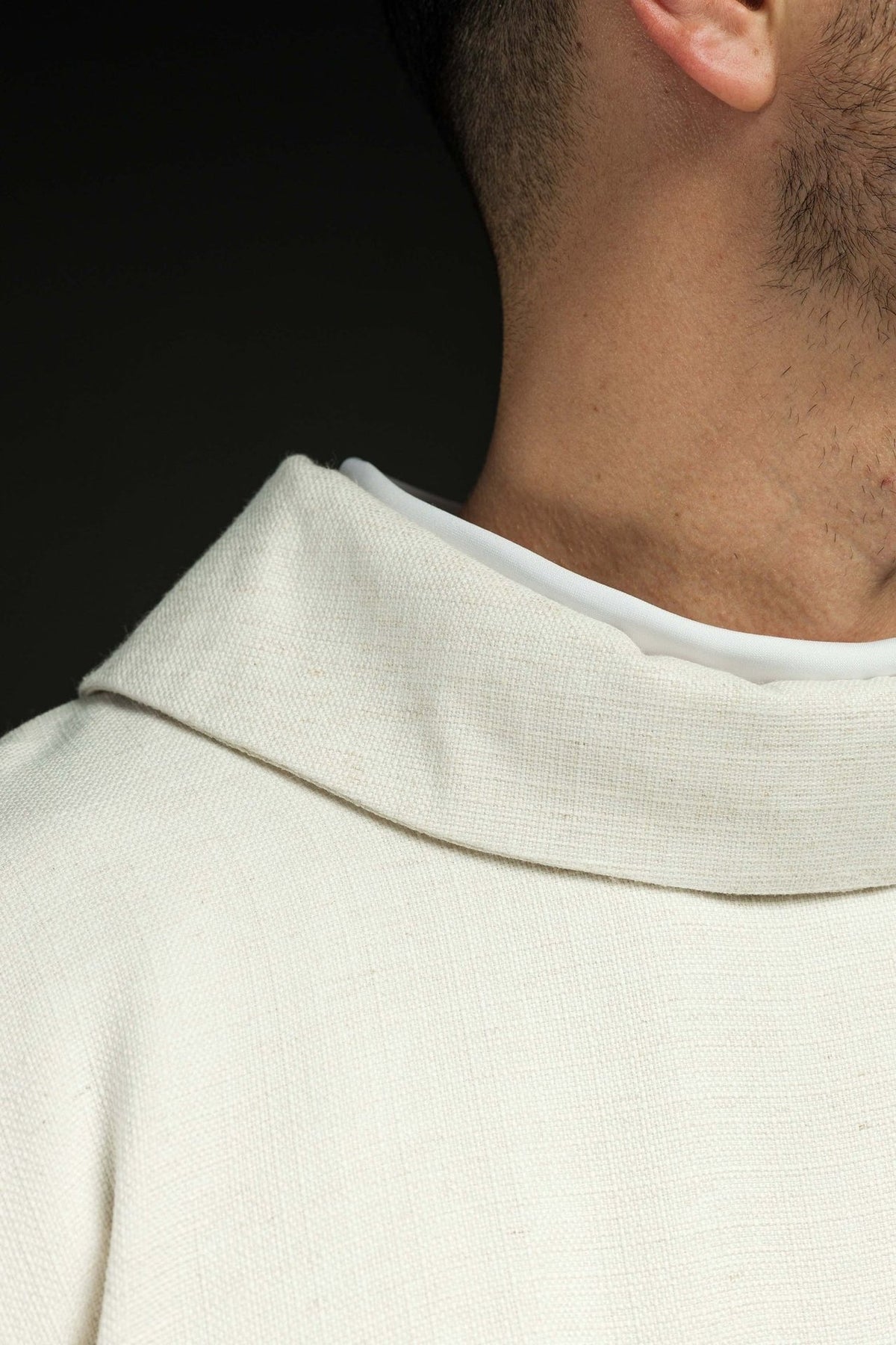 Lamb chasuble close-up showing natural fabric and stand-up collar