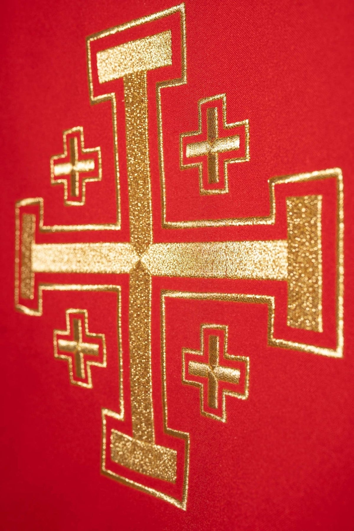 Red chasuble close-up of embroidered gold cross motif