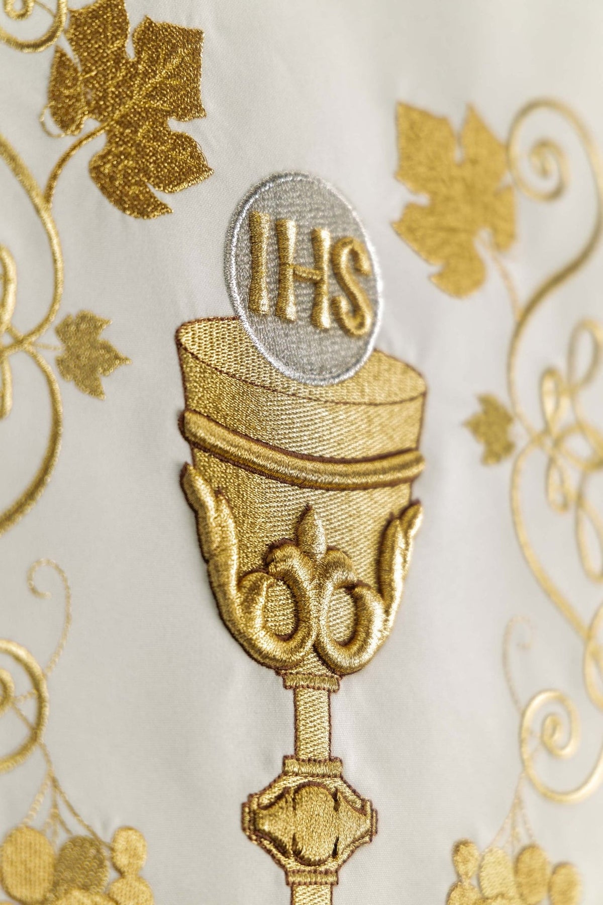 Church lectern cover close-up of the embroidered gold chalice and IHS monogram