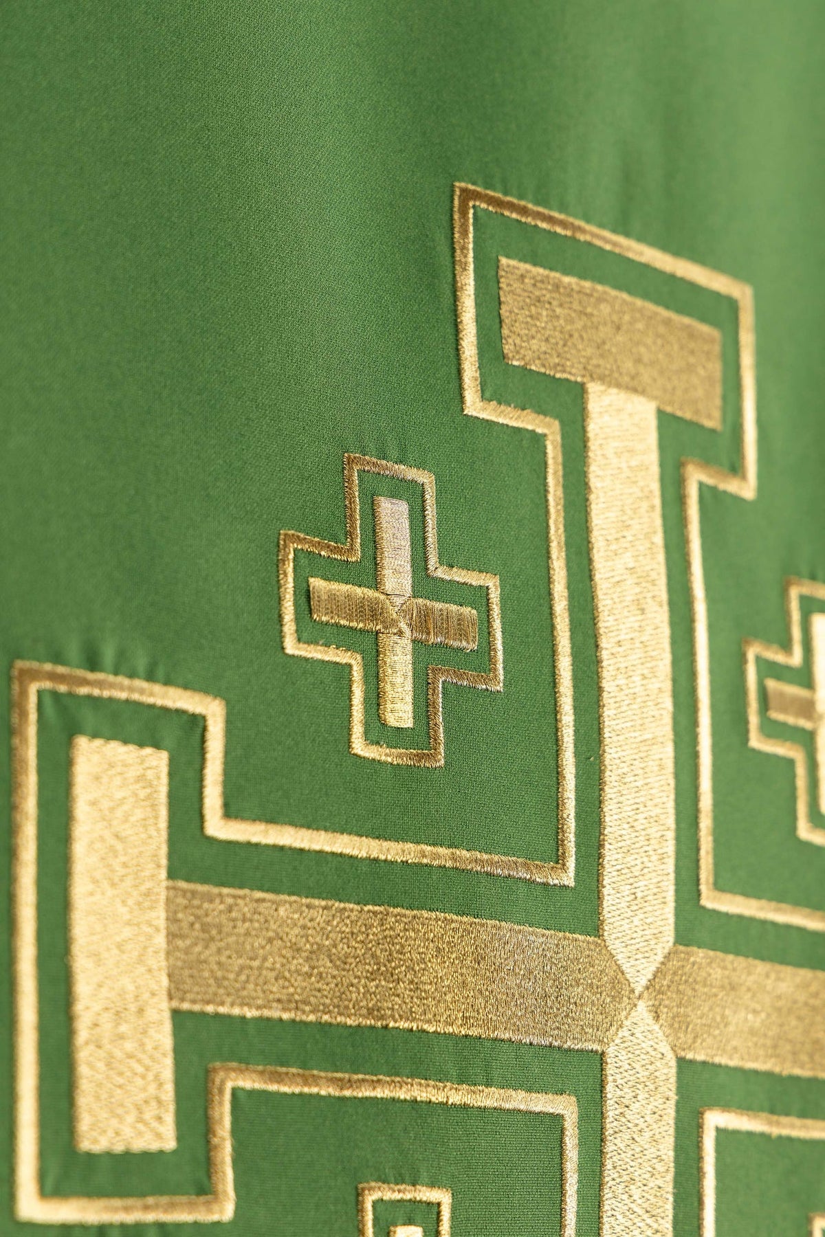 Green church lectern cover angled close-up showing Jerusalem cross embroidery