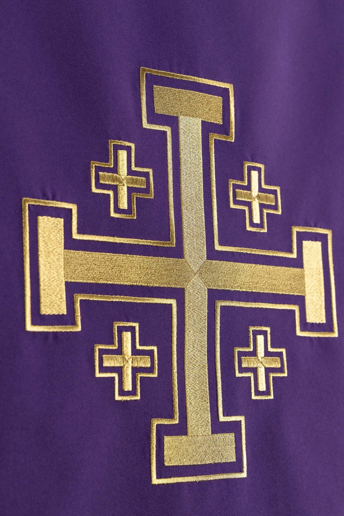 Church lectern cover close-up of gold Jerusalem cross embroidery on purple fabric