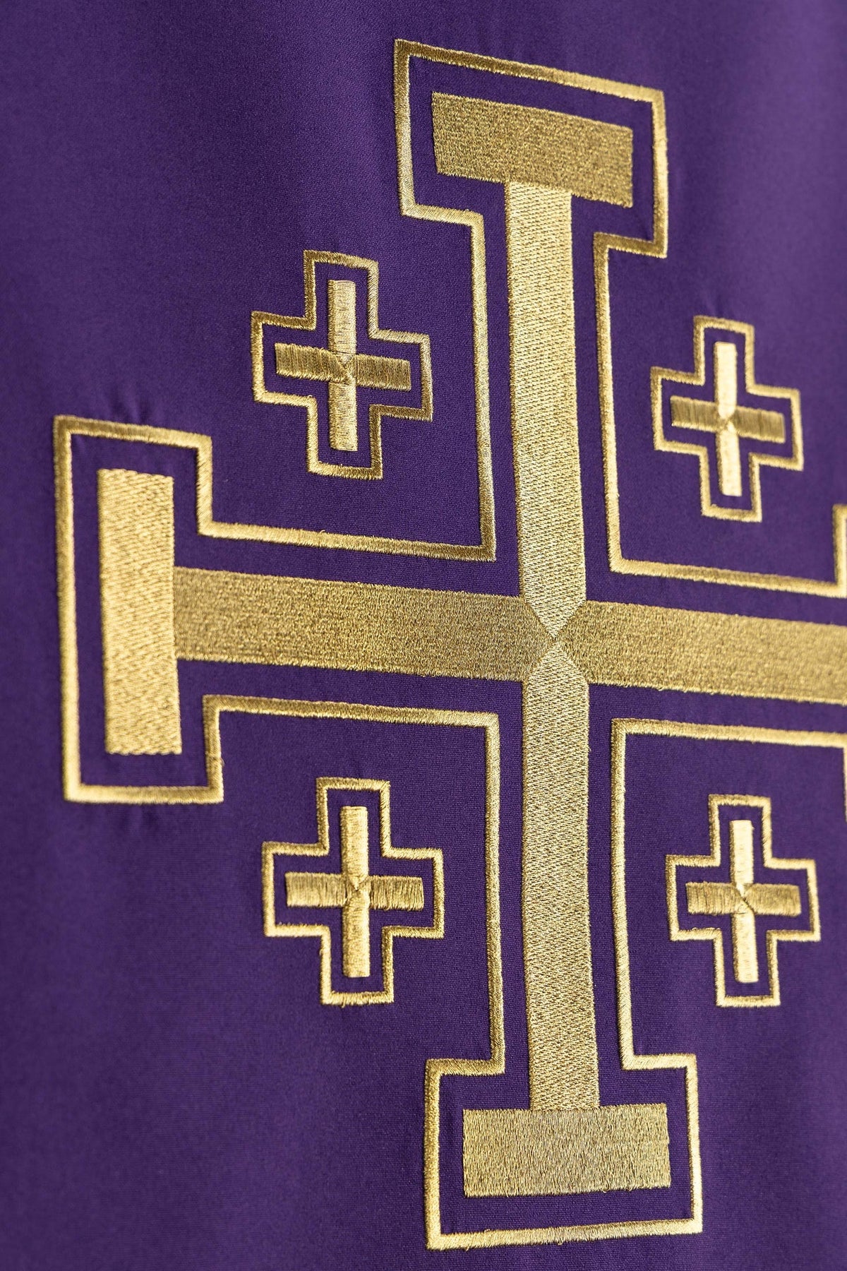 Purple church lectern cover angled close-up of Jerusalem cross embroidery