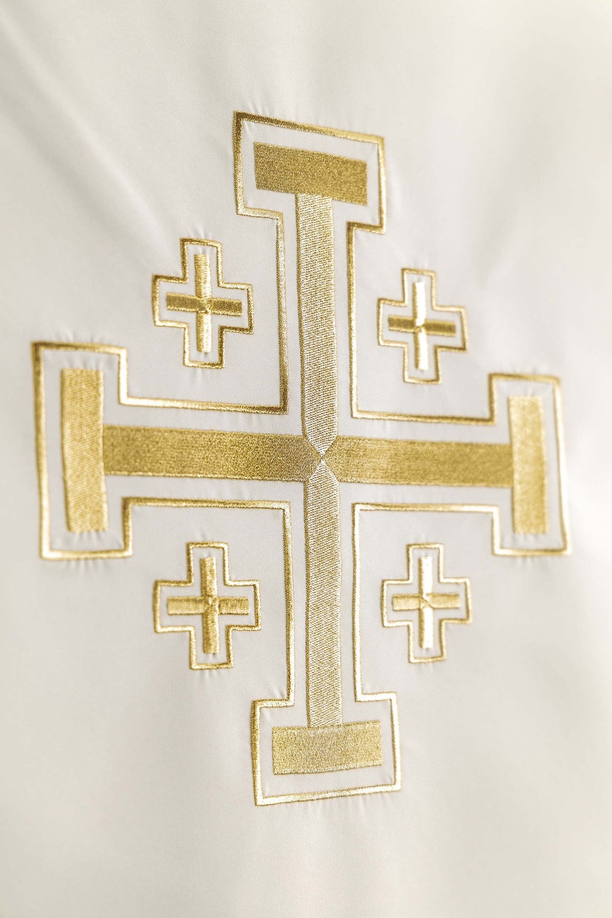 Church lectern cover close-up showing gold Jerusalem cross embroidery