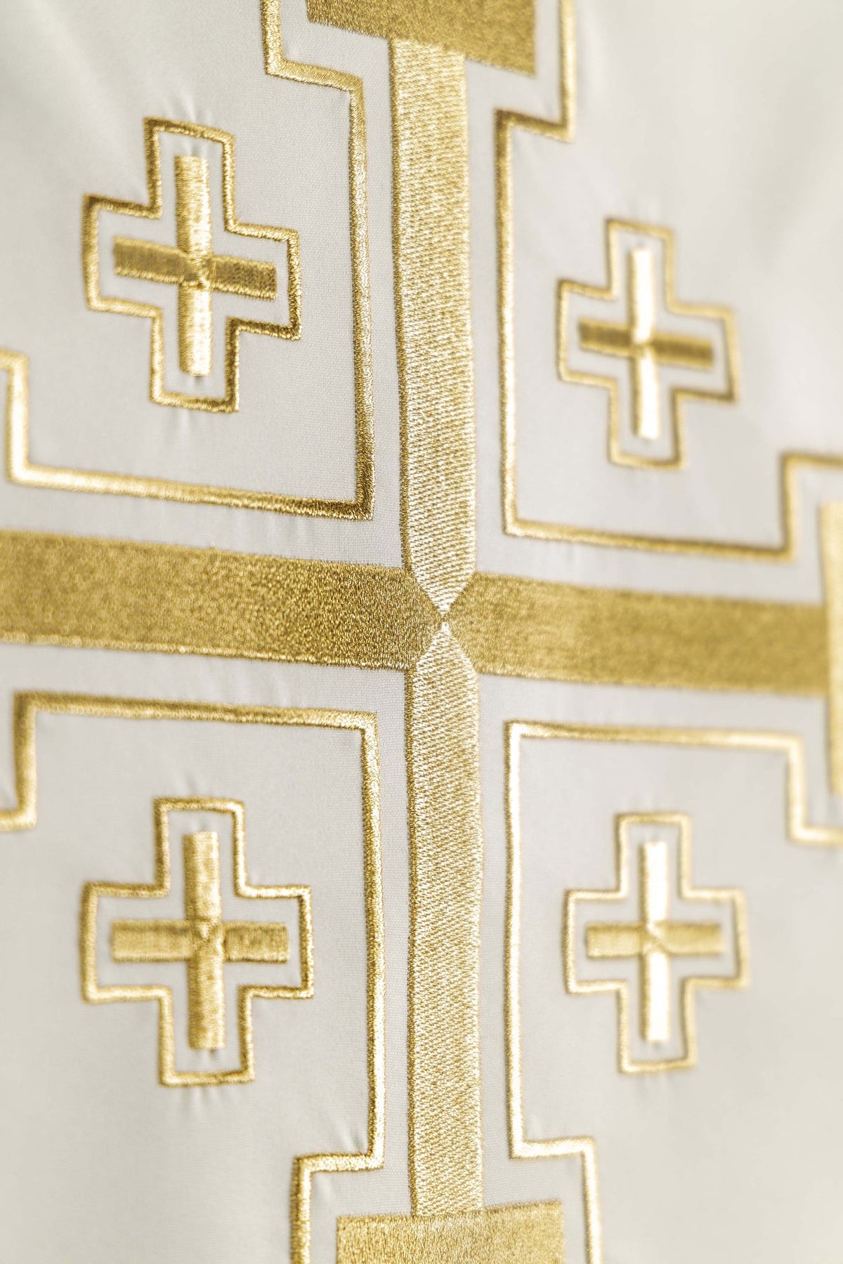 Church lectern cover embroidery close-up showing gold threads and cross details