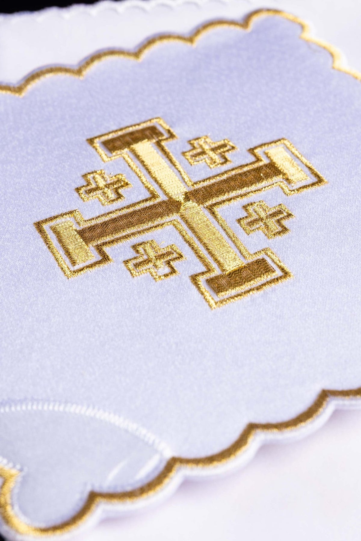 Altar linen set close-up showing gold embroidered cross on white fabric
