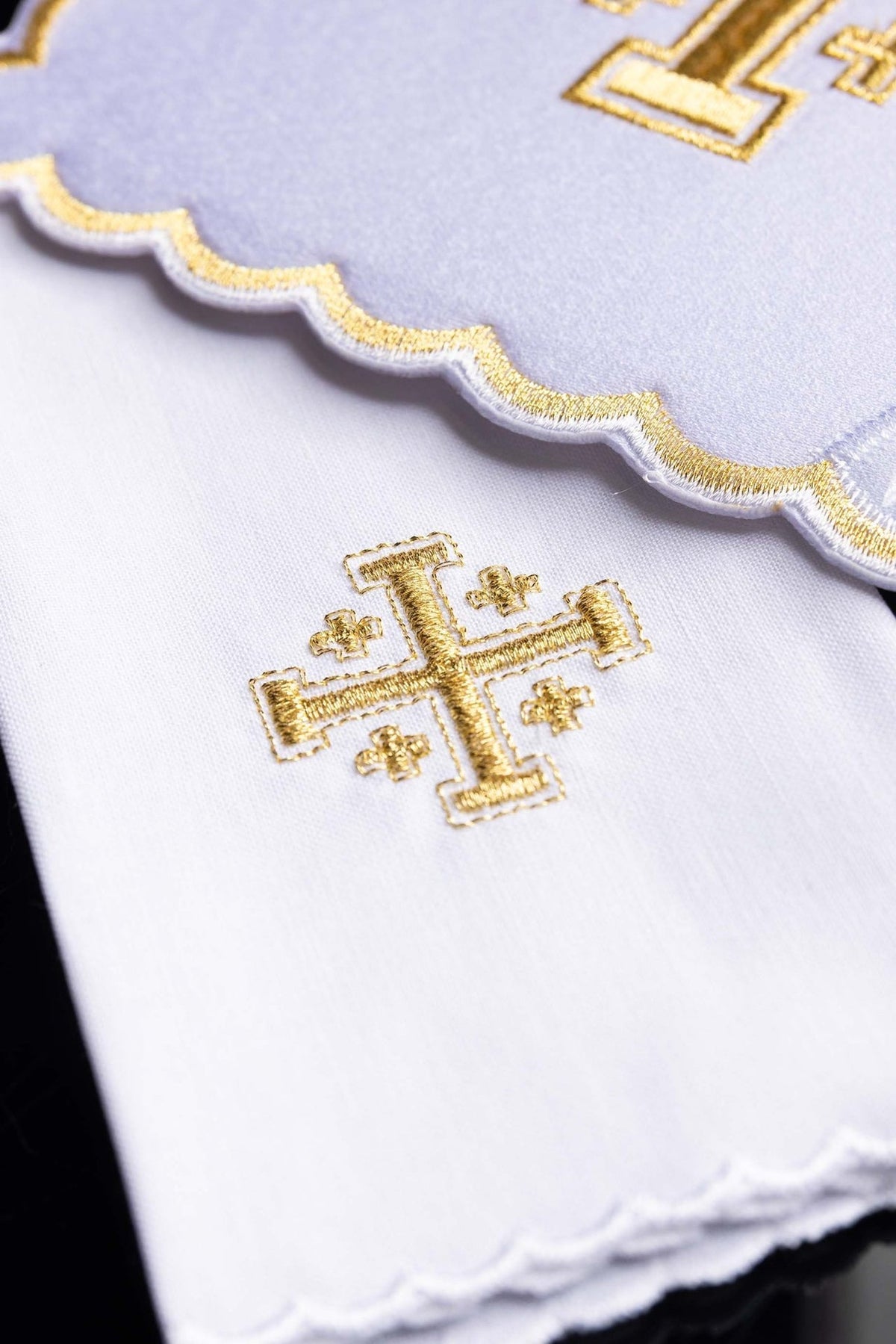 Altar linen set detail showing gold cross embroidery and scalloped white edge