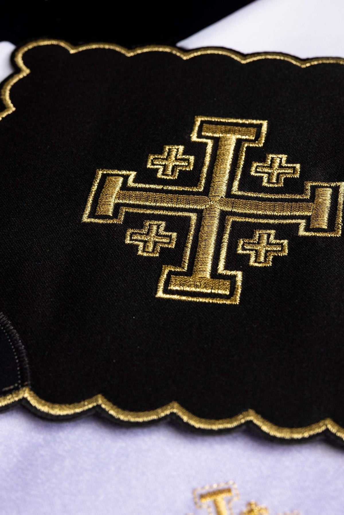 Altar linen set close-up of gold Jerusalem cross embroidery on black cloth