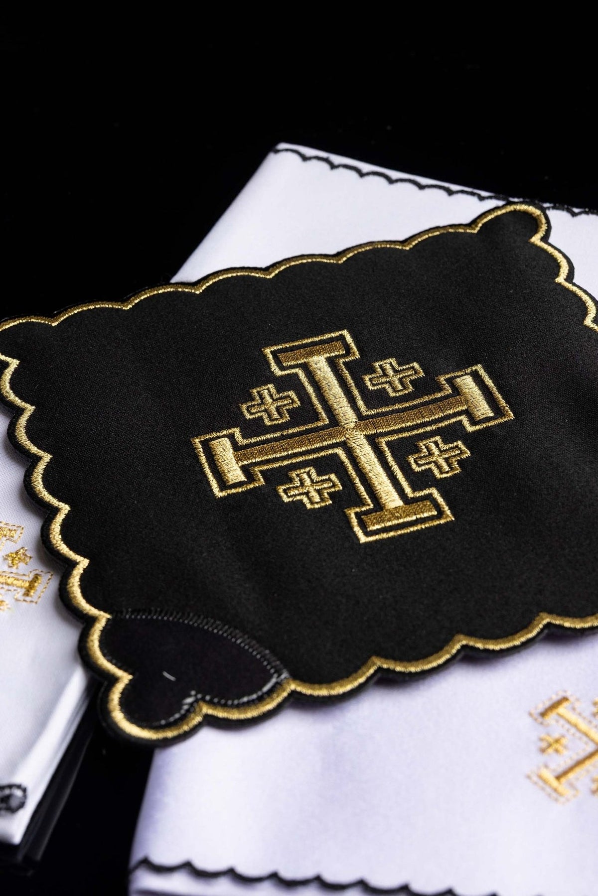 Altar linen set angled close-up of black cloth with gold Jerusalem cross embroidery